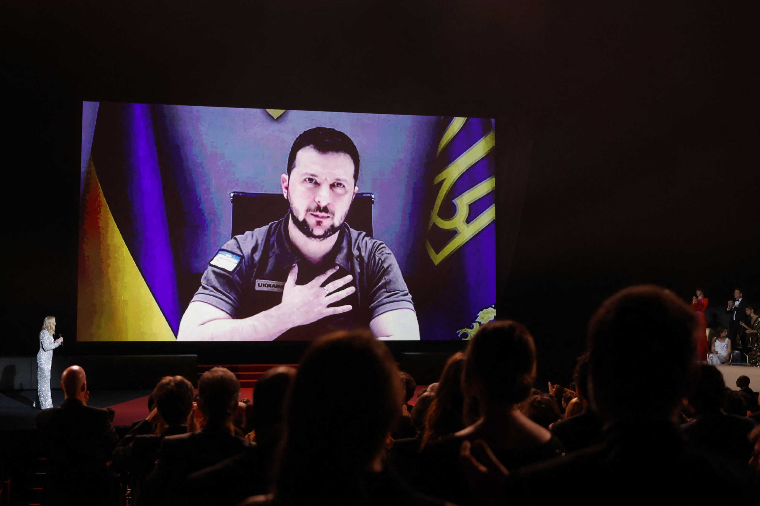 The 75th Cannes Film Festival - Opening ceremony and screening of the film "Coupez" (Final Cut) Out of competition - Cannes, France, May 17, 2022.   Ukraine's President Volodymyr Zelenskiy is seen on a screen as he delivers a video address. REUTERS