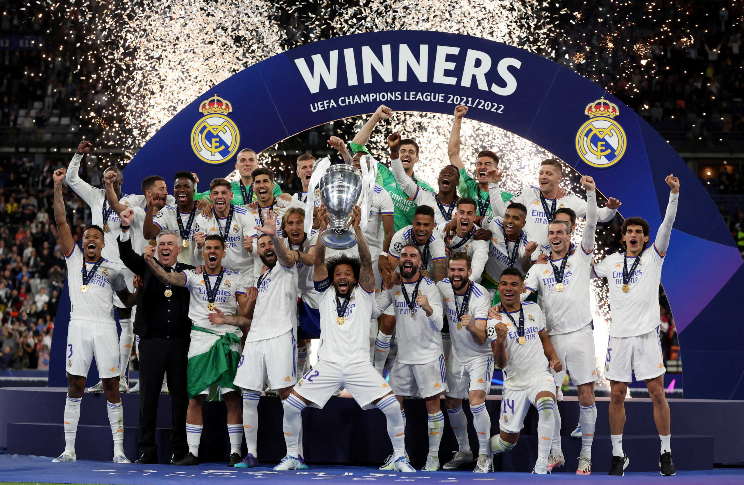 Soccer Football - Champions League Final - Liverpool v Real Madrid - Stade de France, Saint-Denis near Paris, France - May 28, 2022 Real Madrid's Marcelo celebrates with the trophy and teammates after winning the Champions League REUTERS