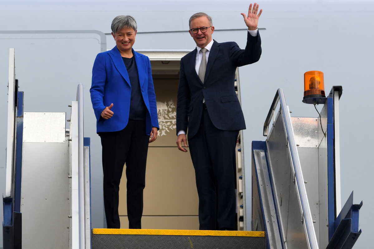 Australian Prime Minister Anthony Albanese, alongside Australian Foreign Minister Penny Wong, waves as the two board the plane to Japan to attend the QUAD leaders meeting in Tokyo, in Canberra, Australia, May 23, 2022.  AAP Image