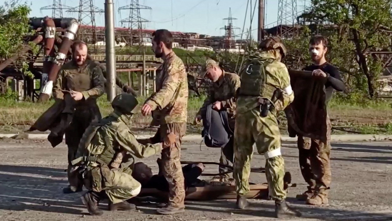 A still image taken from a video released by Russian Defence Ministry shows what it claims are service members of Ukrainian forces, who left the besieged Azovstal steel plant, being searched by the pro-Russian military in Mariupol, Ukraine. Video released May 17, 2022. Russian Defence Ministry