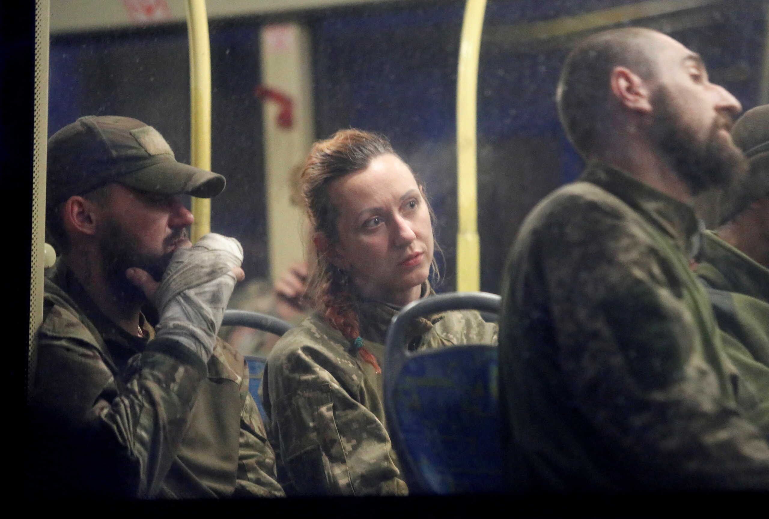 Service members of Ukrainian forces who have surrendered after weeks holed up at Azovstal steel works are seen inside a bus, which arrived under escort of the pro-Russian military at a detention facility in the course of Ukraine-Russia conflict in the settlement of Olenivka in the Donetsk Region, Ukraine May 17, 2022. REUTERS