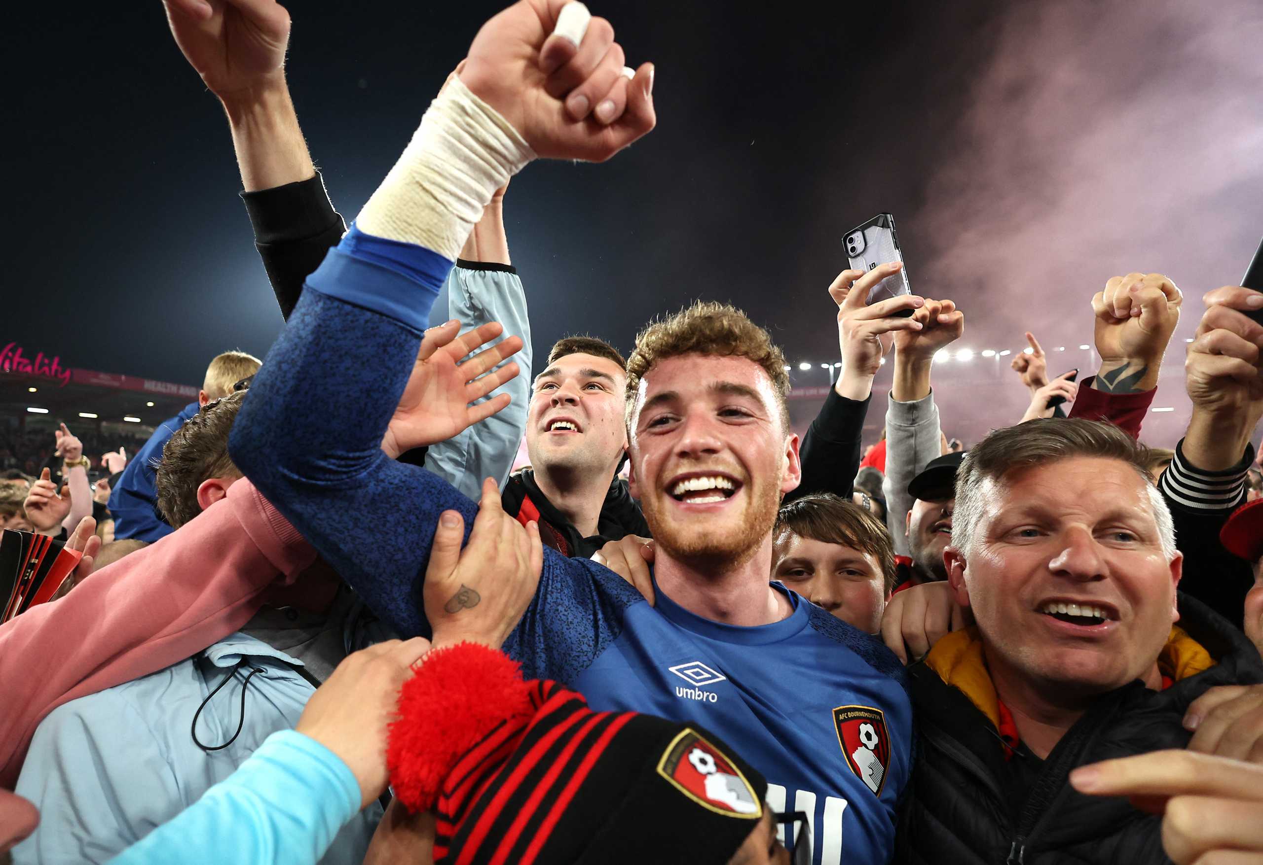 Soccer Football - Championship - AFC Bournemouth v Nottingham Forest - Vitality Stadium, Bournemouth, Britain - May 3, 2022 AFC Bournemouth's Mark Travers celebrates promotion to the premier league with fans on the pitch after the match Action Images via Reuters