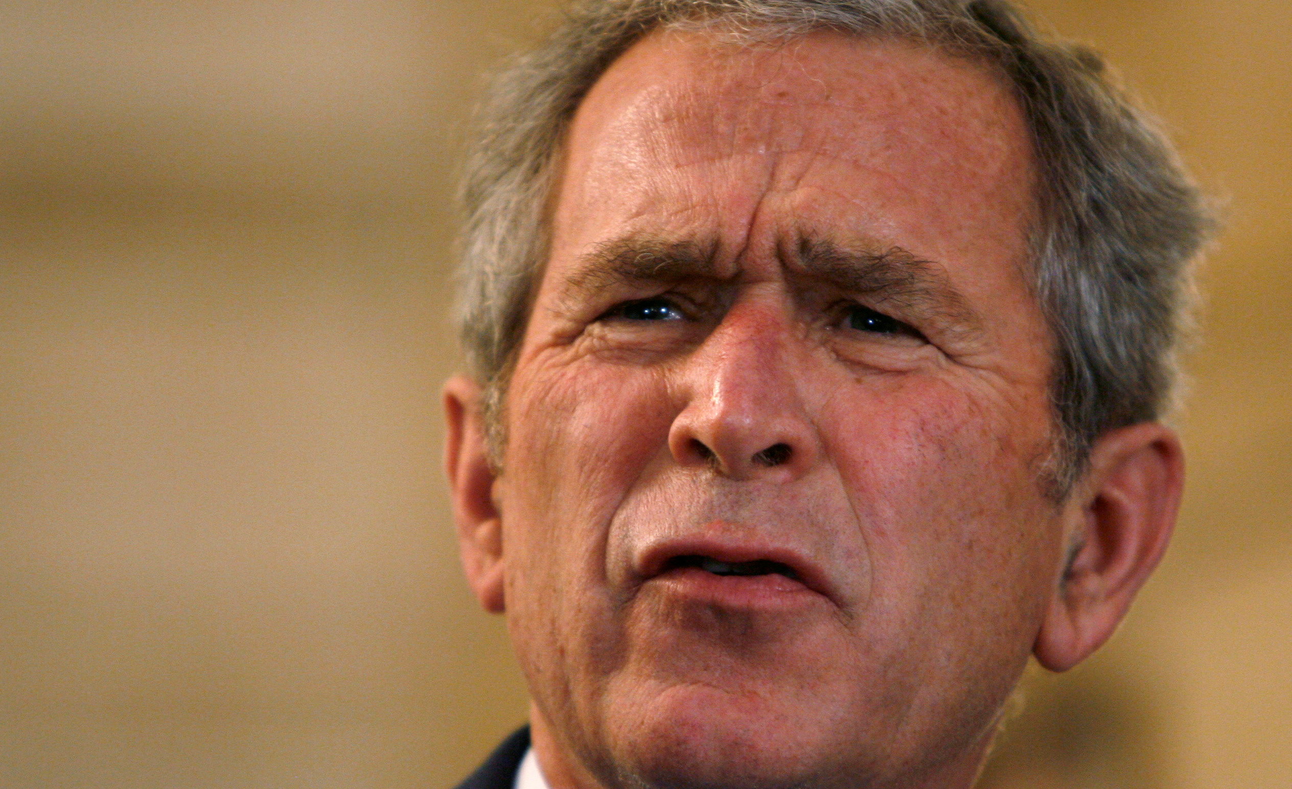 FILE PHOTO: U.S. President George W. Bush reacts to a question after a man threw a shoe at him during a joint statement with Iraqi Prime Minister Nouri al-Maliki in Baghdad, Iraq December 14, 2008.       REUTERS