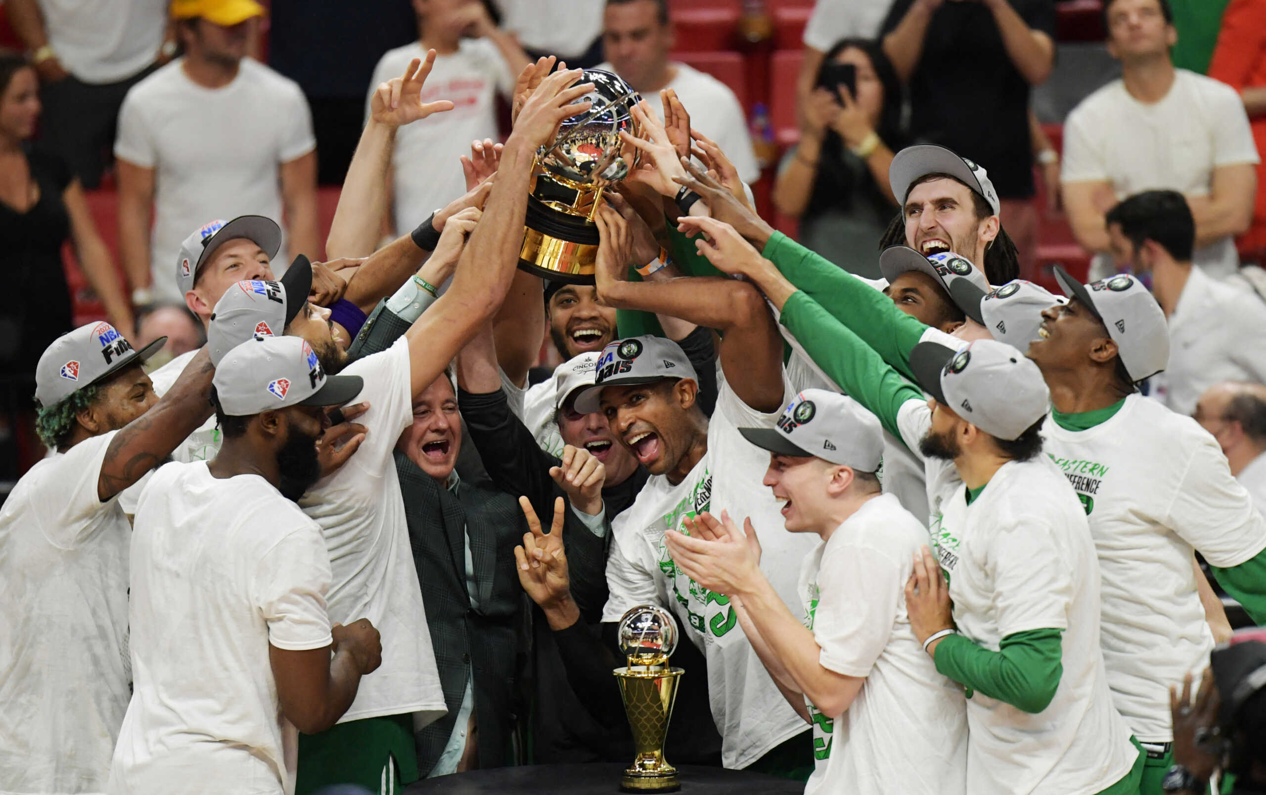 May 29, 2022; Miami, Florida, USA; Members of the Boston Celtics hold up the Bob Cousy Trophy after they defeated the Miami Heat to win the 2022 eastern conference finals at FTX Arena. Mandatory Credit: Jim Rassol-USA TODAY Sports