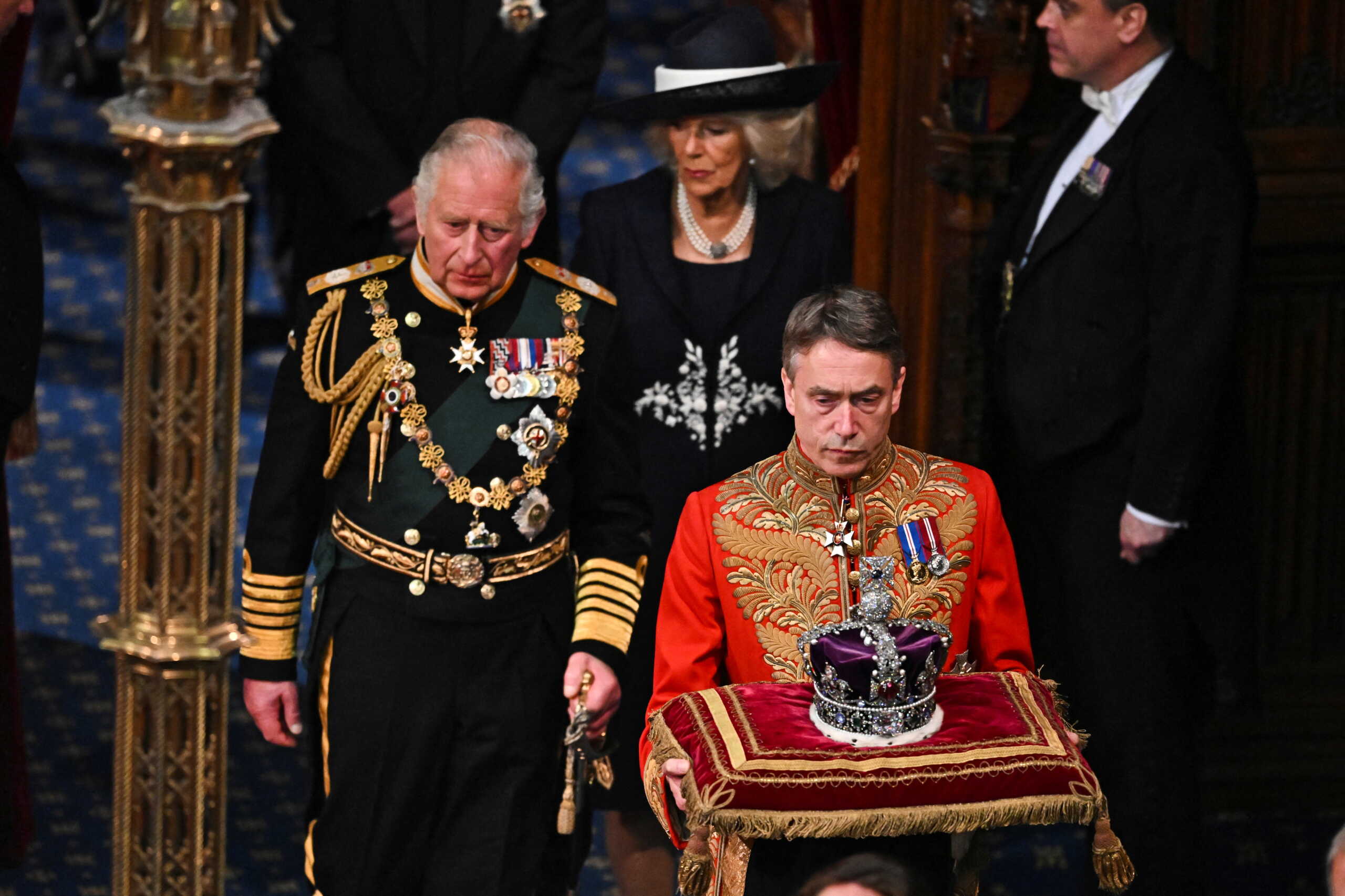Britain's Prince Charles and Camilla, Duchess of Cornwall, follow behind the Imperial State Crown during the State Opening of Parliament in the House of Lords Chamber in the Houses of Parliament in London, Britain, May 10, 2022. Ben Stansall