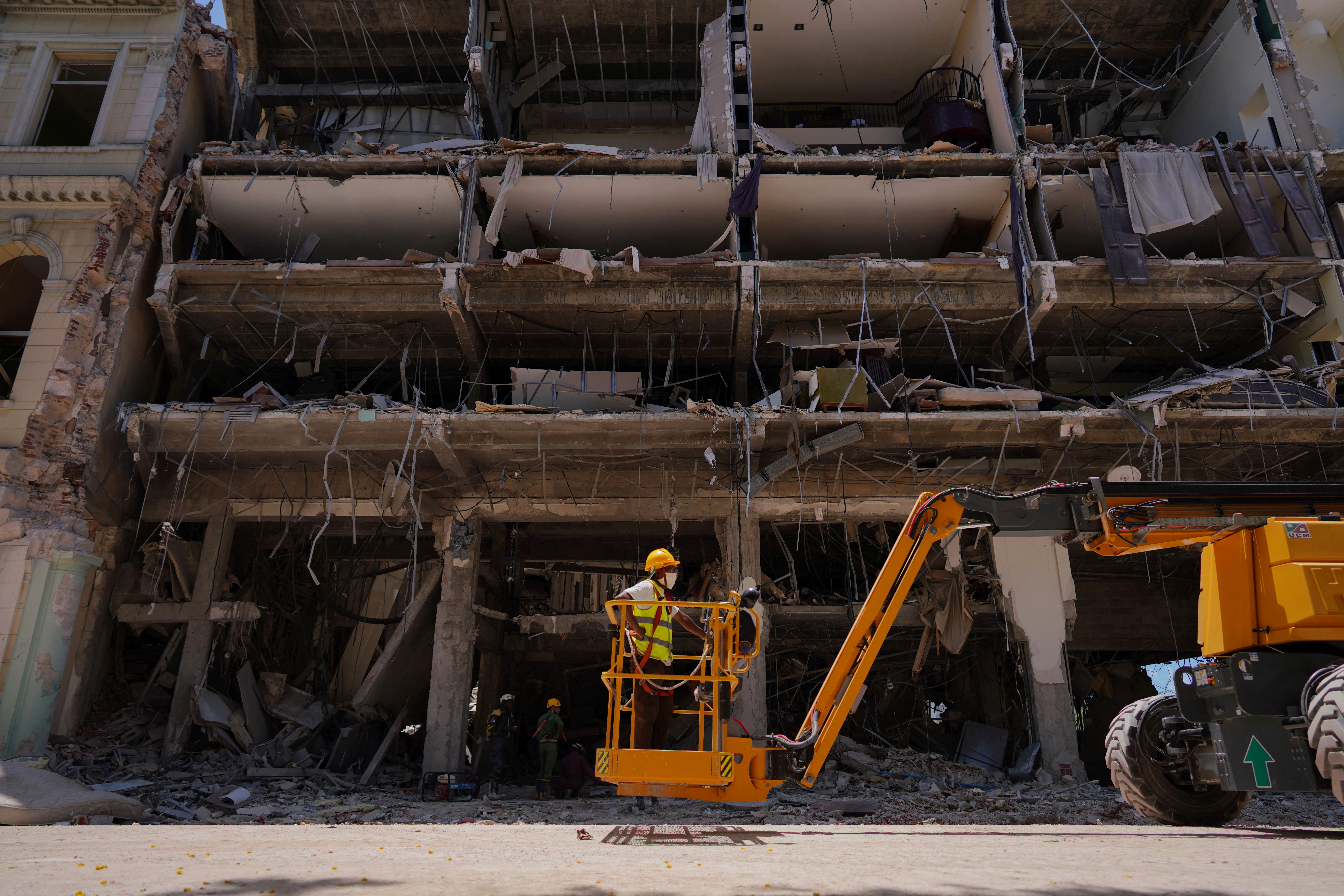 An emergency personnel prepares to be lifted by a crane at the Saratoga Hotel two days after it suffered an explosion, in Havana, Cuba May 8, 2022. REUTERS