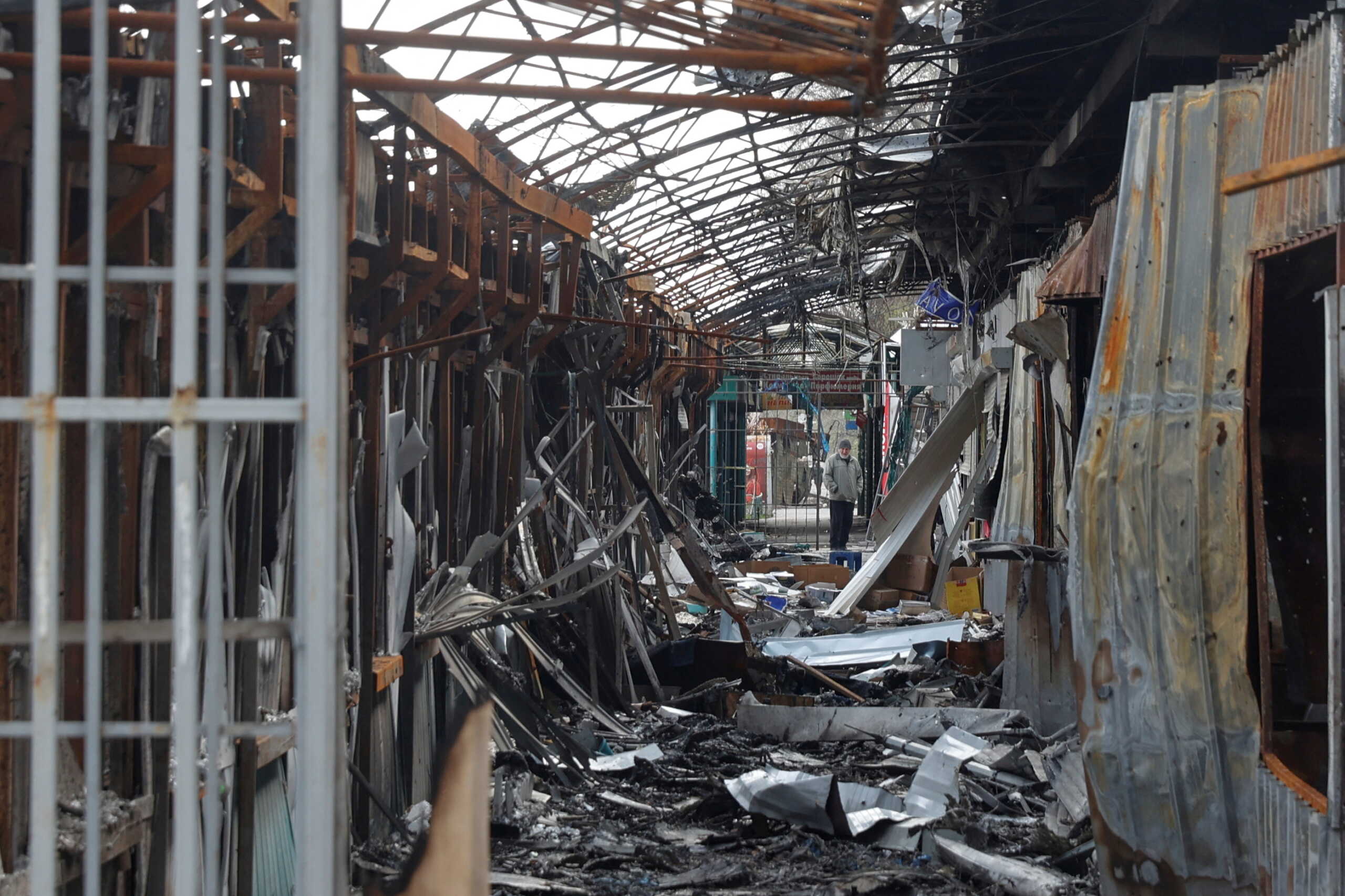 FILE PHOTO: A local resident stands next to debris of an open market destroyed by a military strike, as Russia's attack on Ukraine continues, in Sievierodonetsk, Luhansk region, Ukraine April 16, 2022.  REUTERS
