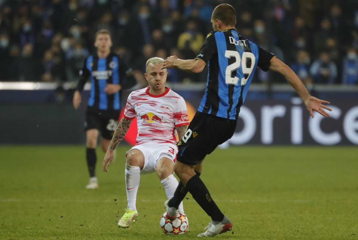 epa09601560 Angelino of RB Leipzig (L) and Bas Dost of Club Brugge (R) in action during the UEFA Champions League group A soccer match between Club Brugge and RB Leipzig in Bruges, Belgium, 24 November 2021.  EPA