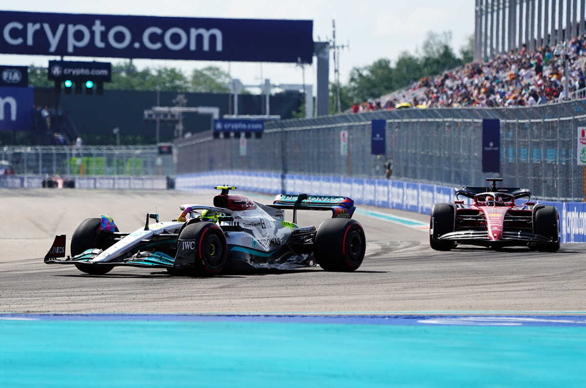 May 6, 2022; Miami Gardens, Florida, USA; Mercedes driver Lewis Hamilton of Britain and Ferrari driver Charles Leclerc of Monaco race into turn 1 through the circuit during qualifying for the Miami Grand Prix at Miami International Autodrome. Mandatory Credit: John David Mercer-USA TODAY Sports