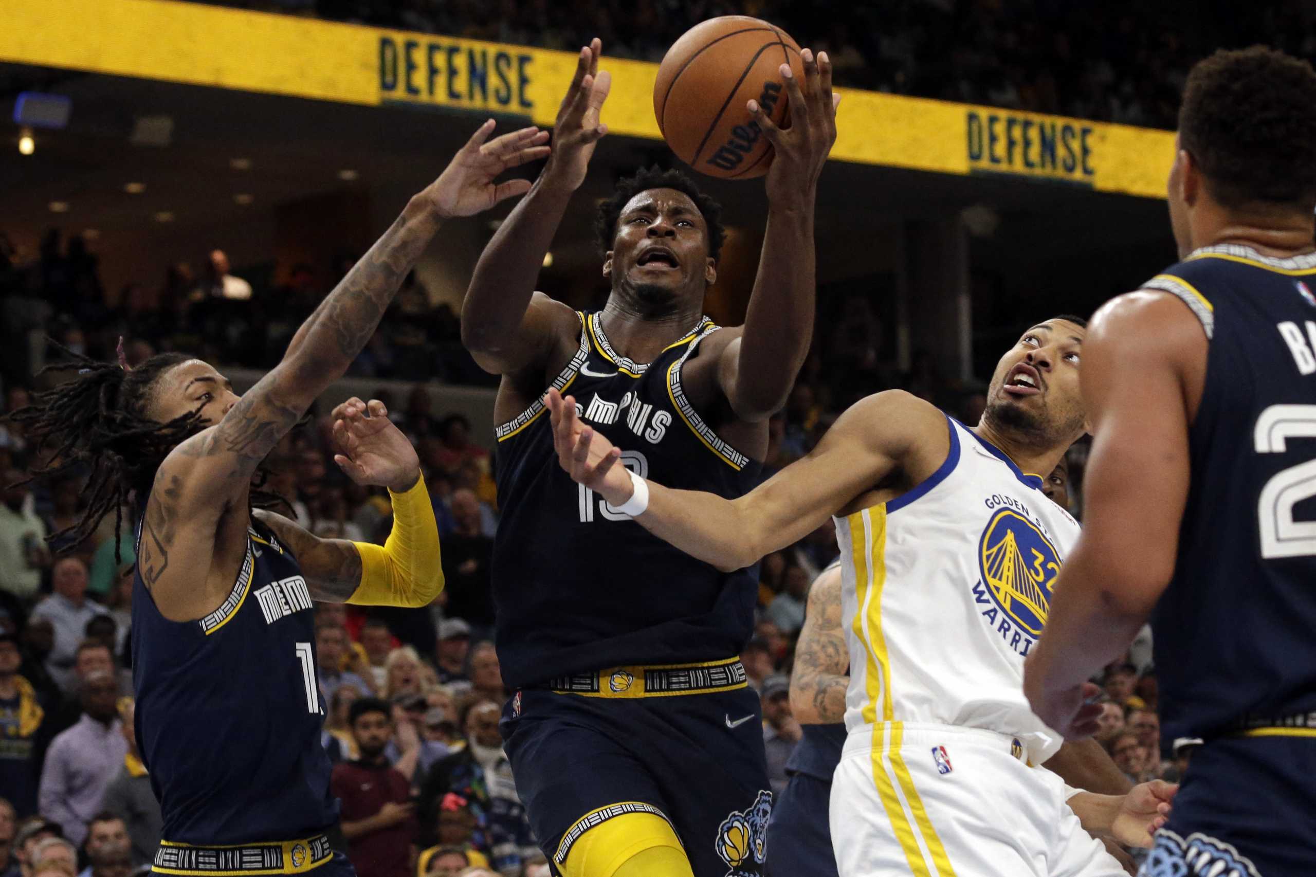 May 3, 2022; Memphis, Tennessee, USA; Memphis Grizzlies forward Jaren Jackson Jr. (13) collects a rebound over Golden State Warriors forward Otto Porter Jr. (32) during the second half during game two of the second round for the 2022 NBA playoffs at FedExForum. Mandatory Credit: Petre Thomas-USA TODAY Sports