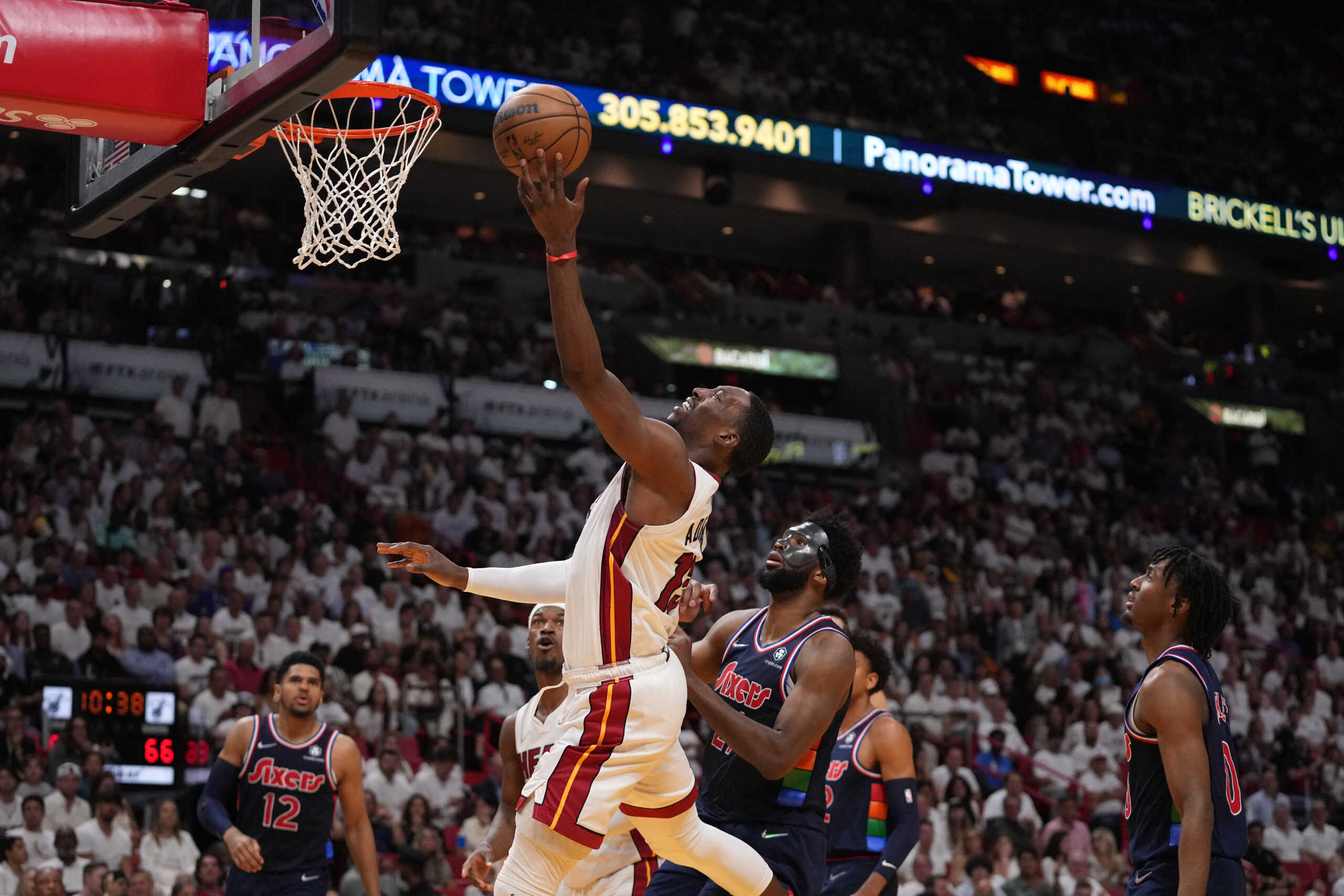 May 10, 2022; Miami, Florida, USA; Miami Heat center Bam Adebayo (13) puts up a shot around Philadelphia 76ers center Joel Embiid (21) during the second half in game five of the second round for the 2022 NBA playoffs at FTX Arena. Mandatory Credit: Jasen Vinlove-USA TODAY Sports