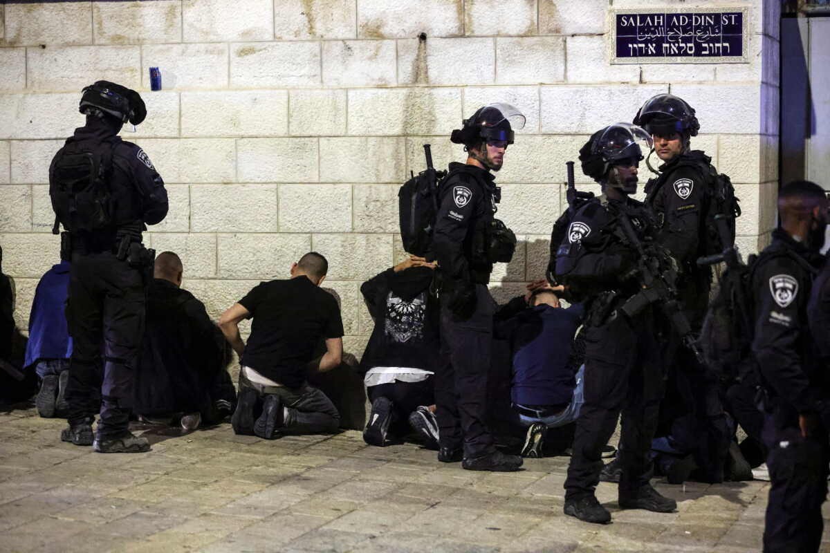 Israeli security personnel detain people during clashes with Palestinians around the funeral of Waleed Al Shareef outside Jerusalem's Old City May 16, 2022. REUTERS