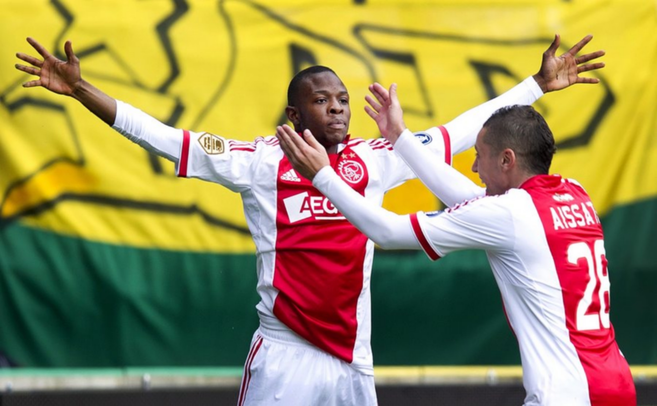 epa03150744 Ajax Amsterdam's Jody Lukoki (L) celebrates with his teammate Ismail Aissati (R) after scoring the 1-0 lead against ADO Den Haag during the Dutch Eredivisie soccer match in The Hague, Netherlands, 18 March 2012.  EPA