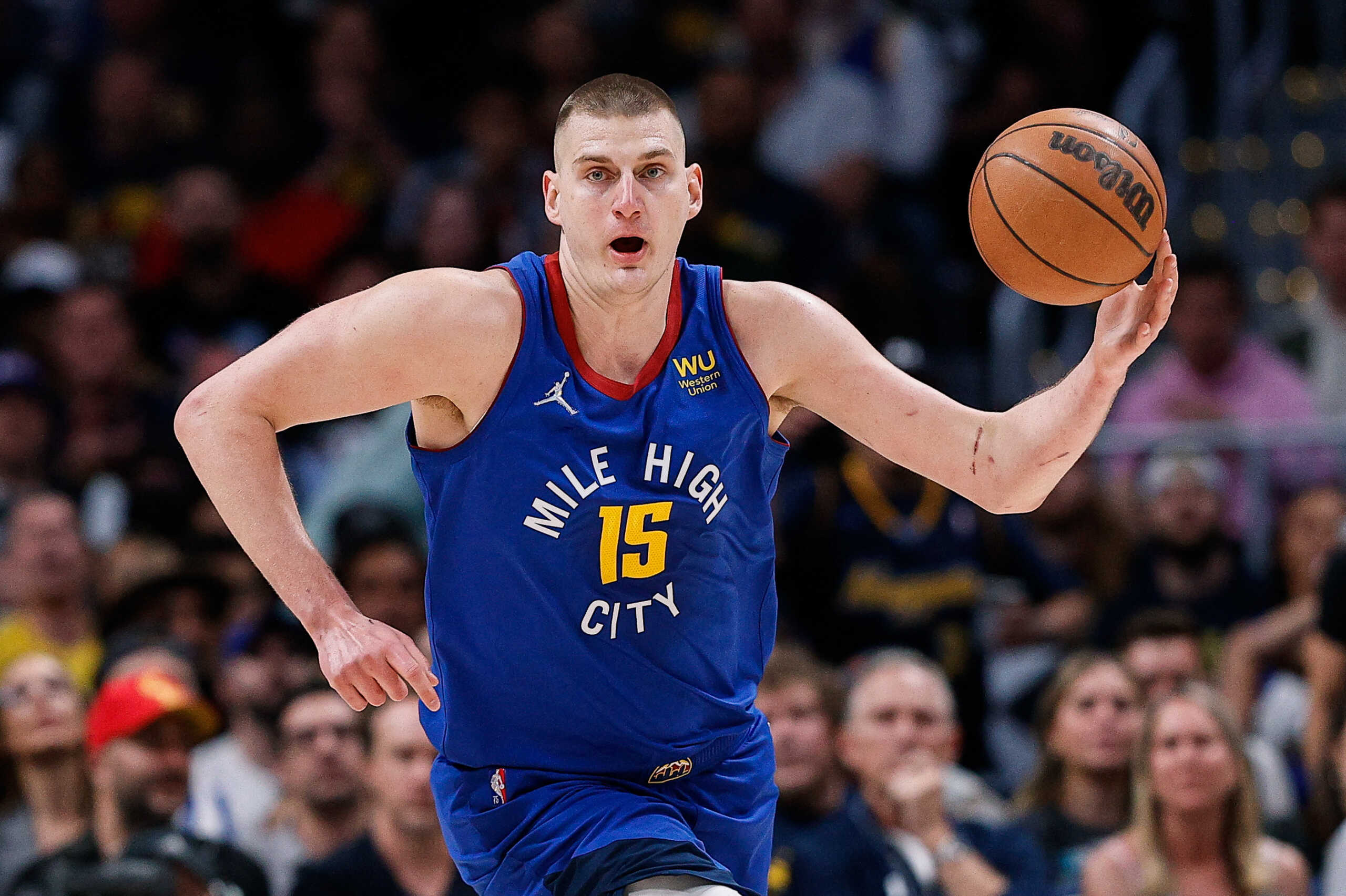 Apr 21, 2022; Denver, Colorado, USA; Denver Nuggets center Nikola Jokic (15) controls the ball in the first quarter against the Golden State Warriors during game three of the first round for the 2022 NBA playoffs at Ball Arena. Mandatory Credit: Isaiah J. Downing-USA TODAY Sports