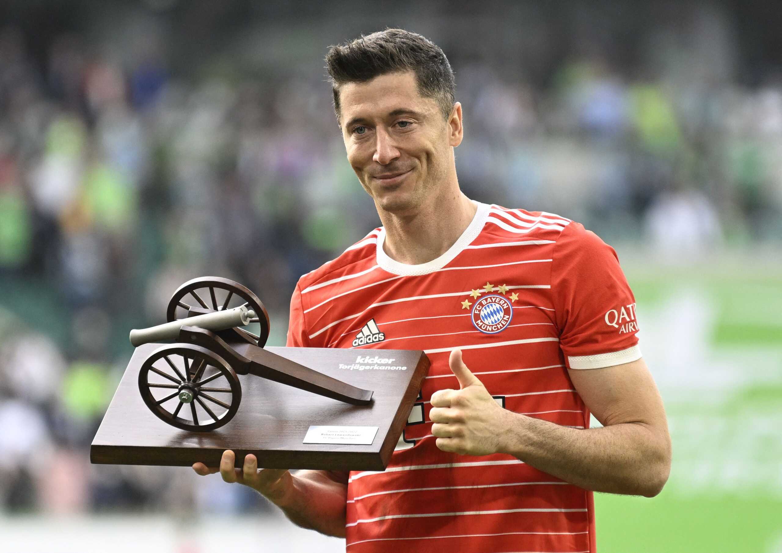 Soccer Football - Bundesliga - VfL Wolfsburg v Bayern Munich - Volkswagen Arena, Wolfsburg, Germany - May 14, 2022 Bayern Munich's Robert Lewandowski celebrates with the top goalscorer trophy after the match REUTERS