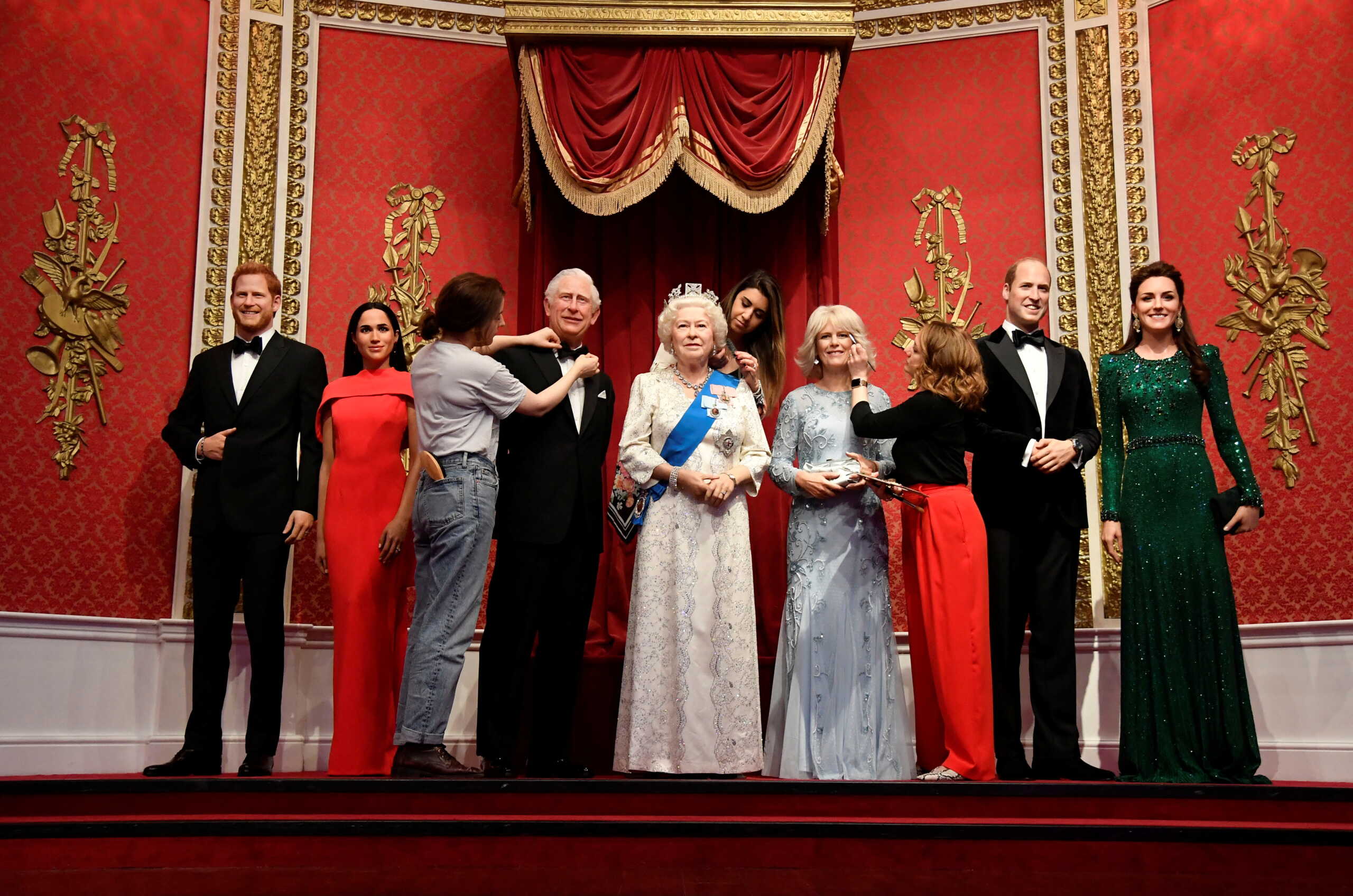 Studio artists retouch wax work models of senior members of the British royal family in a new grouping and outfits, ahead of Queen Elizabeth's Platinum Jubilee celebrations at Madame Tussauds in London, Britain, May 25, 2022. REUTERS