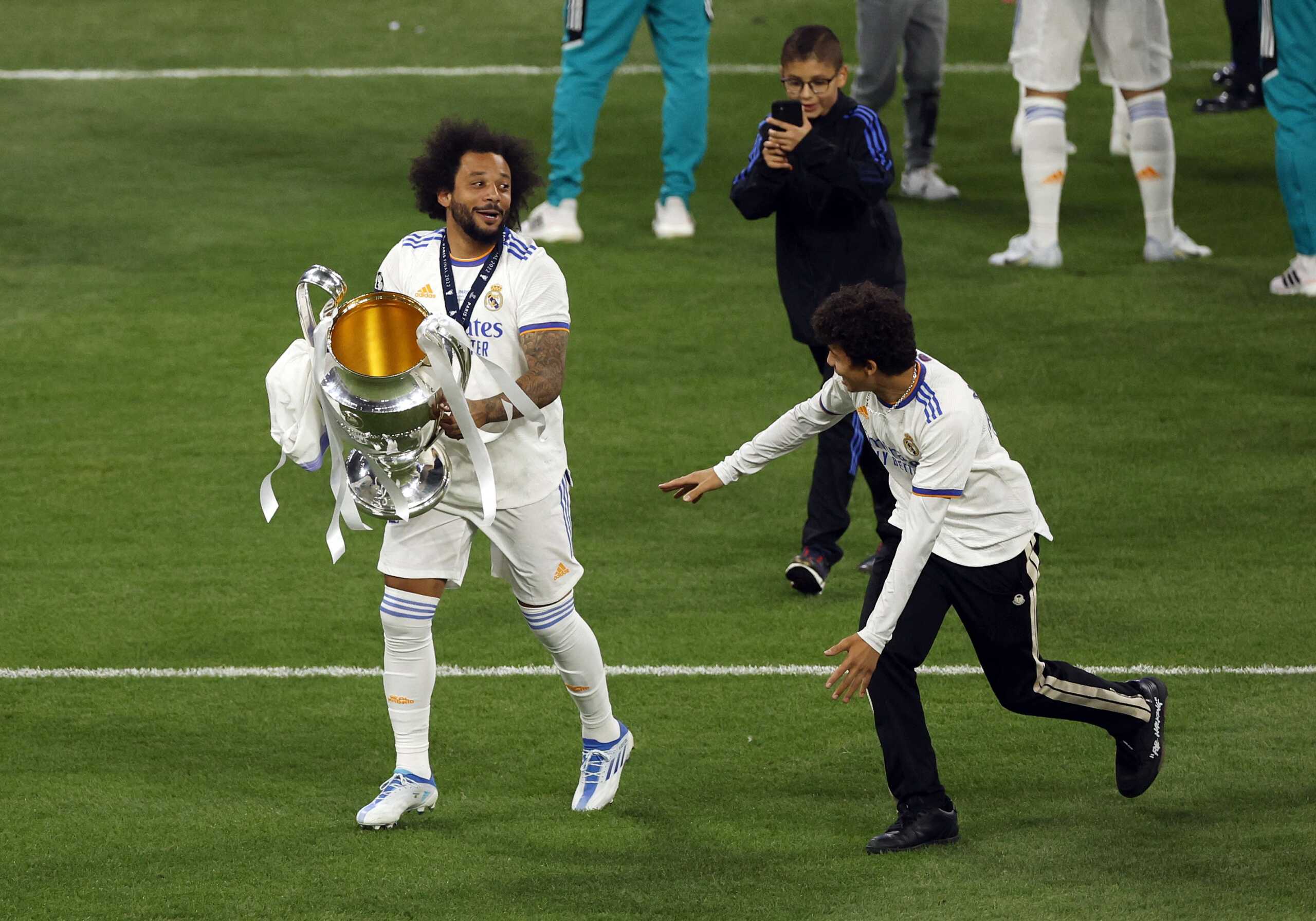Soccer Football - Champions League Final - Liverpool v Real Madrid - Stade de France, Saint-Denis near Paris, France - May 28, 2022  Real Madrid's Marcelo celebrates with the trophy after winning the Champions League REUTERS