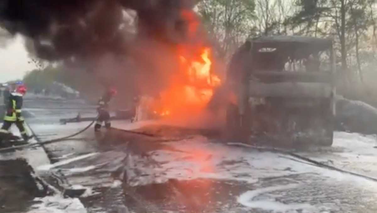 Firefighters spray water onto a vehicle on fire after a fuel truck collided with a bus on the Kyiv-Chop highway in Sitne, Dubna district, Rivne region Ukraine in this still image taken from a handout video released May 3, 2022.  State Emergency Service of Ukraine