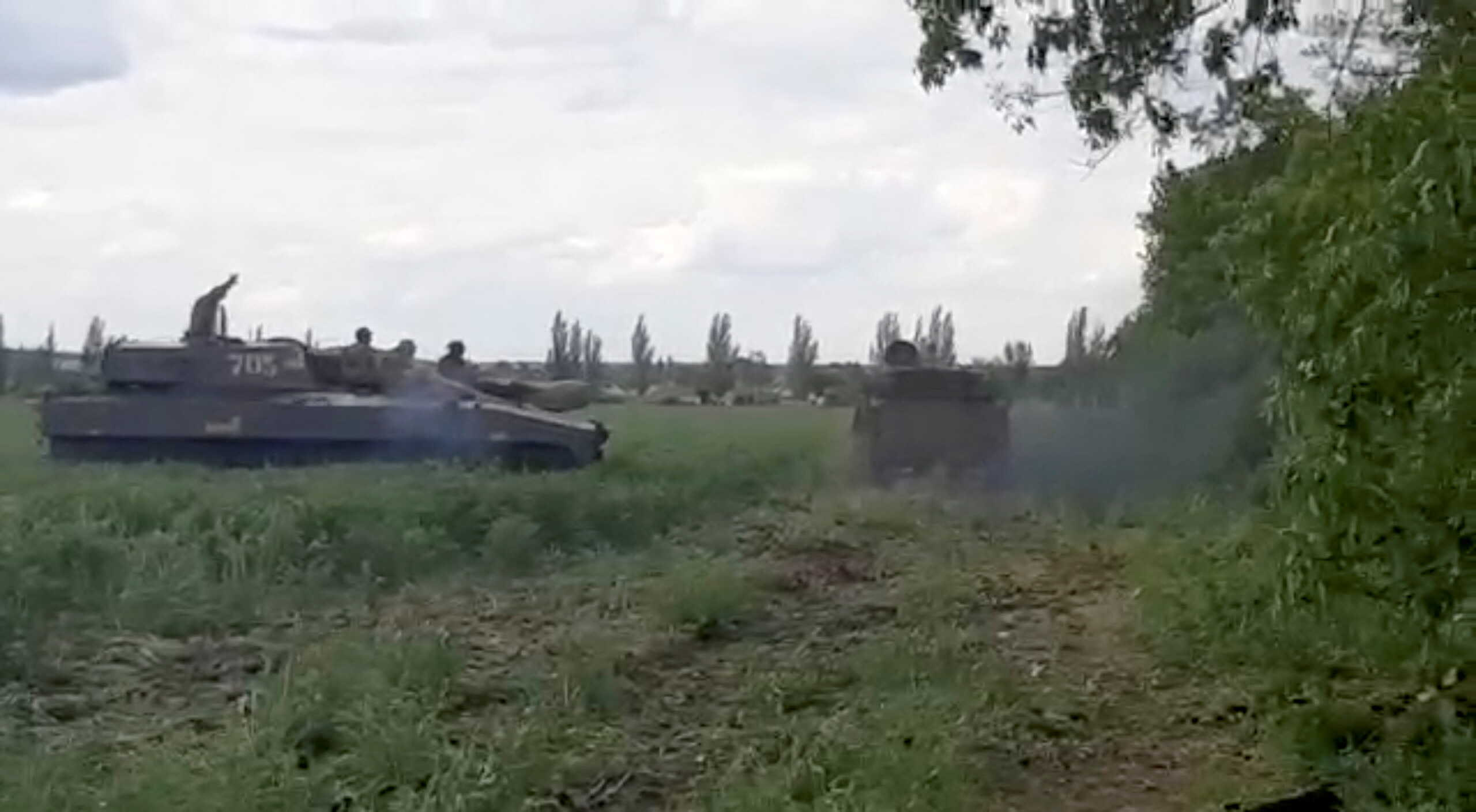 Ukrainian military members ride on howitzers in location given as Donbas region, Ukraine in this still image taken from a video obtained by Reuters May 23, 2022.  THIS IMAGE HAS BEEN SUPPLIED BY A THIRD PARTY.