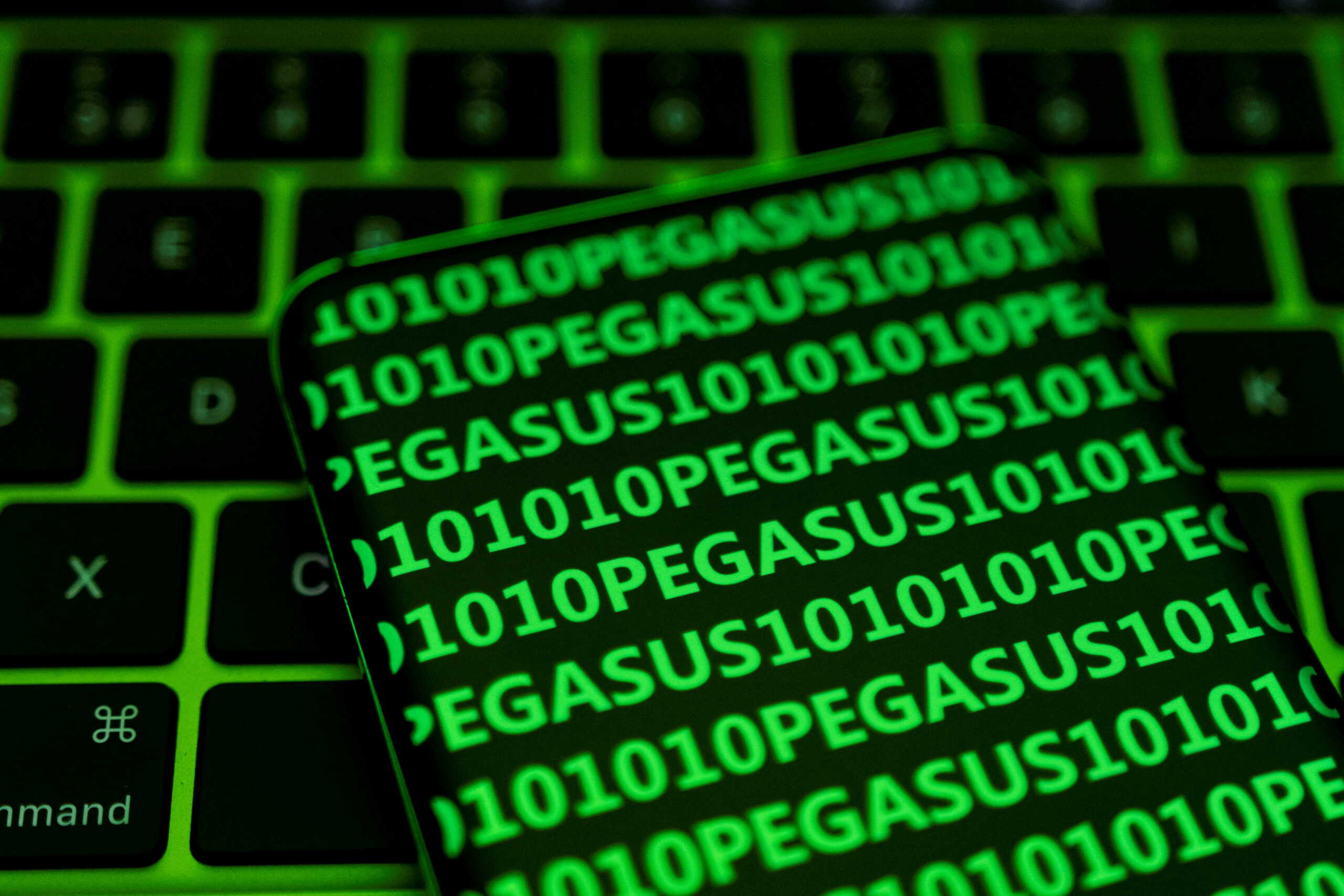 The word Pegasus and binary code are displayed on a smartphone which is placed on a keyboard in this illustration taken May 4, 2022. REUTERS