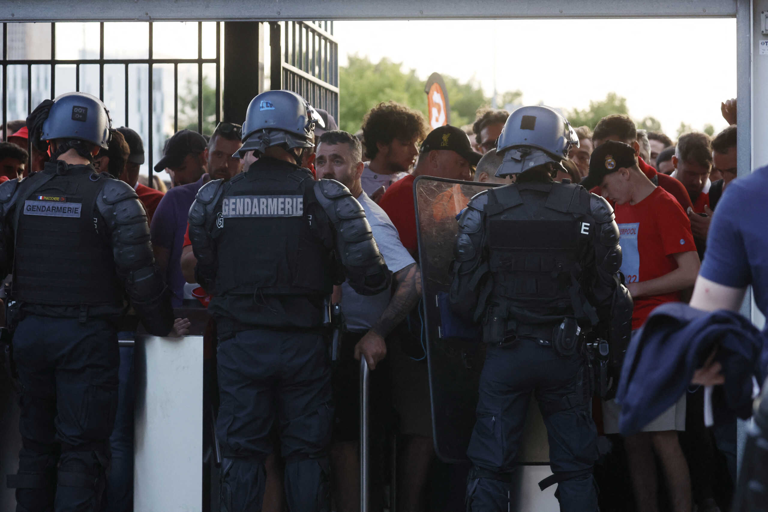 Soccer Football - Champions League Final - Liverpool v Real Madrid - Stade de France, Saint-Denis near Paris, France - May 28, 2022  Fans and police officers at the turnstiles inside the stadium as the match is delayed REUTERS