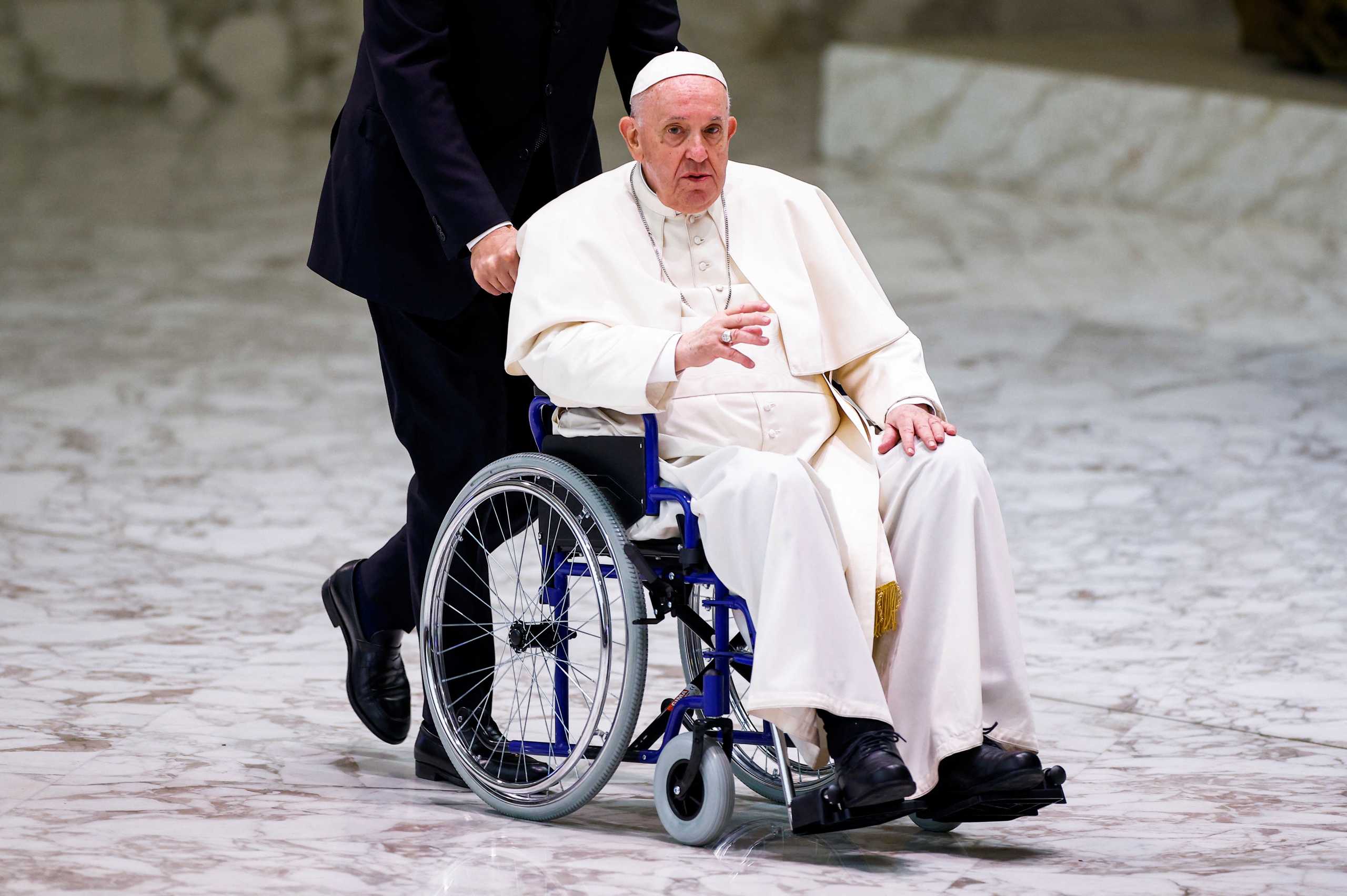 Pope Francis arrives on a wheelchair to meet with participants in the plenary assembly of the International Union of Superiors General (IUSG) at the Vatican, May 5, 2022. REUTERS