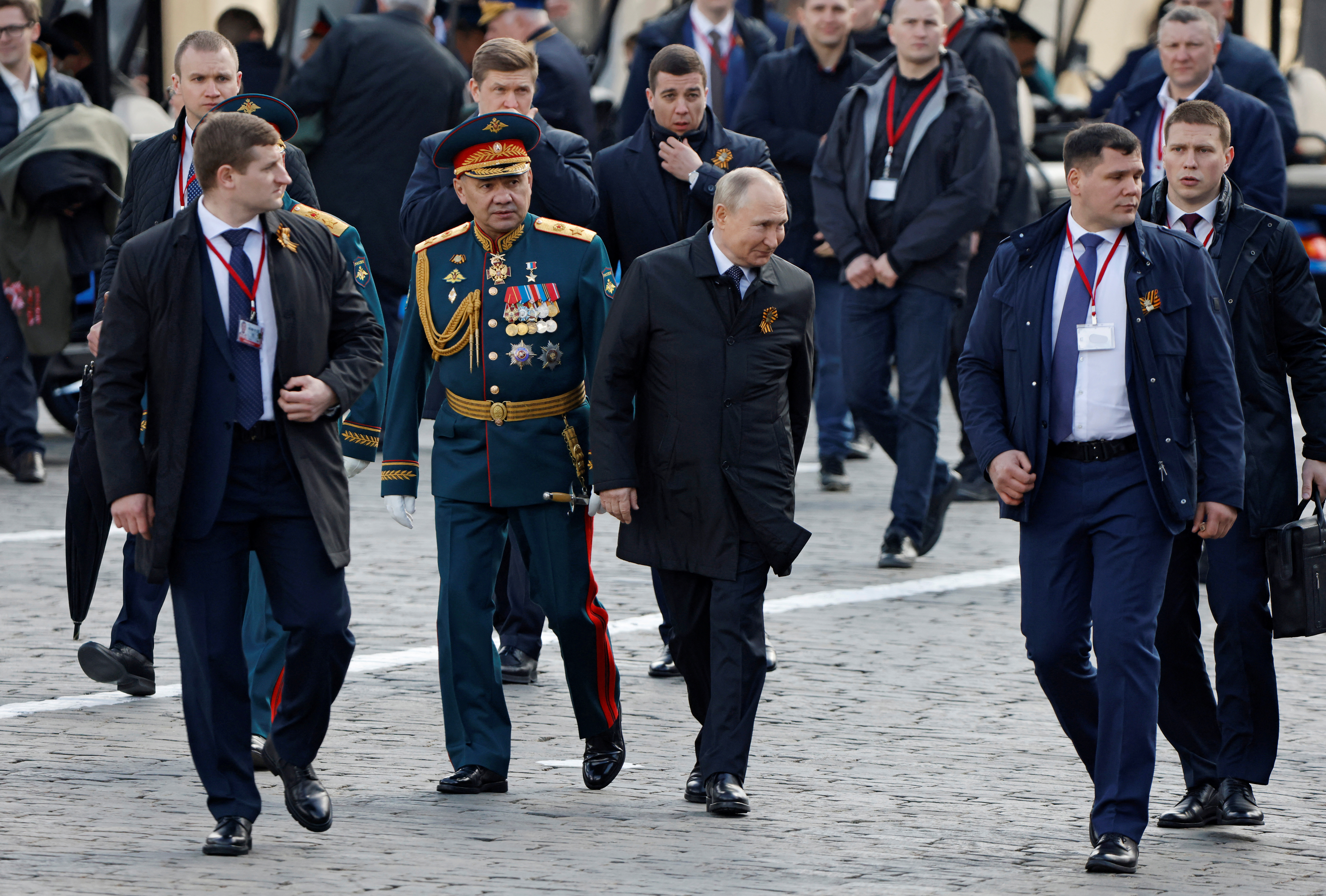 Russian President Vladimir Putin and Defence Minister Sergei Shoigu walk after a military parade on Victory Day, which marks the 77th anniversary of the victory over Nazi Germany in World War Two, in Red Square in central Moscow, Russia May 9, 2022. REUTERS