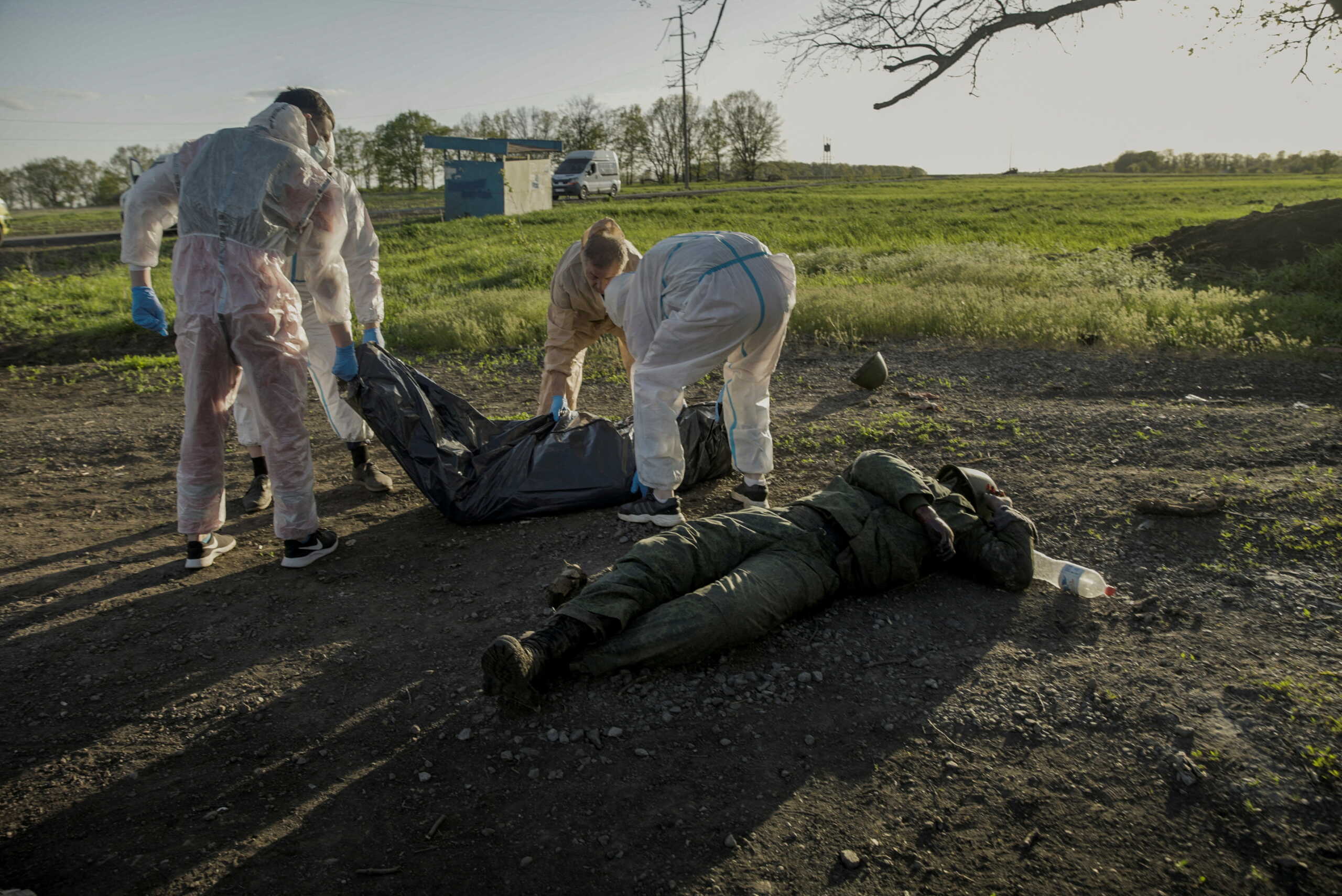 SENSITIVE MATERIAL. THIS IMAGE MAY OFFEND OR DISTURB Volunteers collect bodies of Russian soldiers found in the village of Vilkhivka after it was retaken by Ukrainian Armed Forces, in Kharkiv region, Ukraine May 9, 2022. Picture taken May 9, 2022. REUTERS