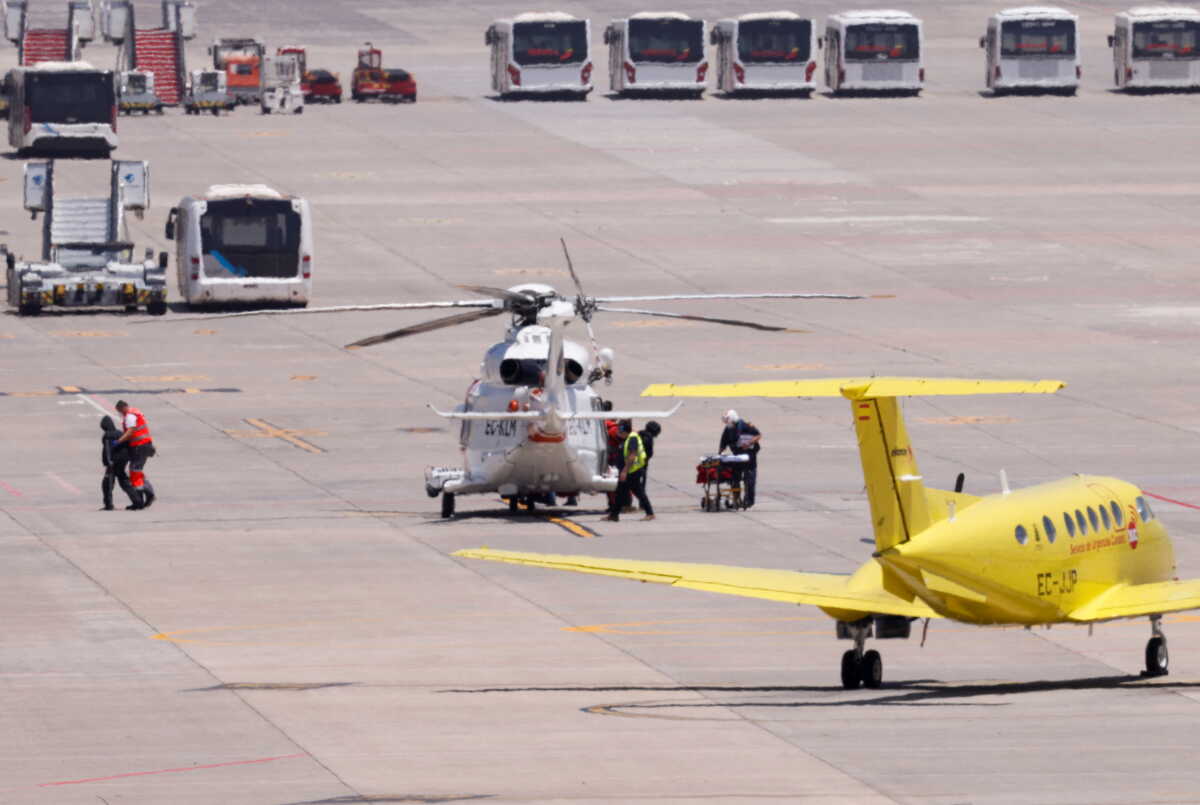 Medical staff take migrants to a Red Cross ambulance to be treated after being rescued by a helicopter 65 miles away from Gran Canaria Island, in Telde, Canary Islands, Spain, May 9, 2022. REUTERS
