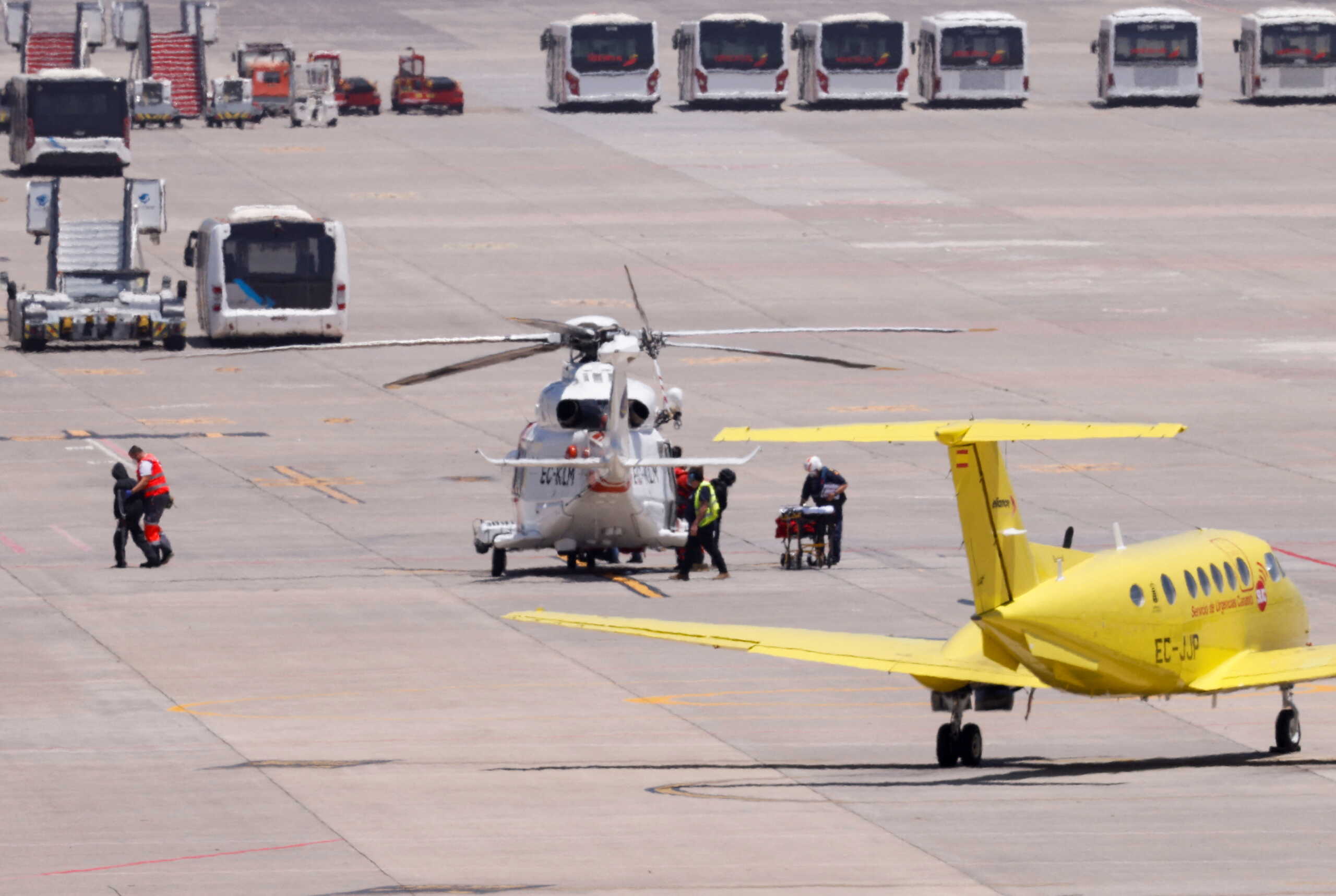 Medical staff take migrants to a Red Cross ambulance to be treated after being rescued by a helicopter 65 miles away from Gran Canaria Island, in Telde, Canary Islands, Spain, May 9, 2022. REUTERS