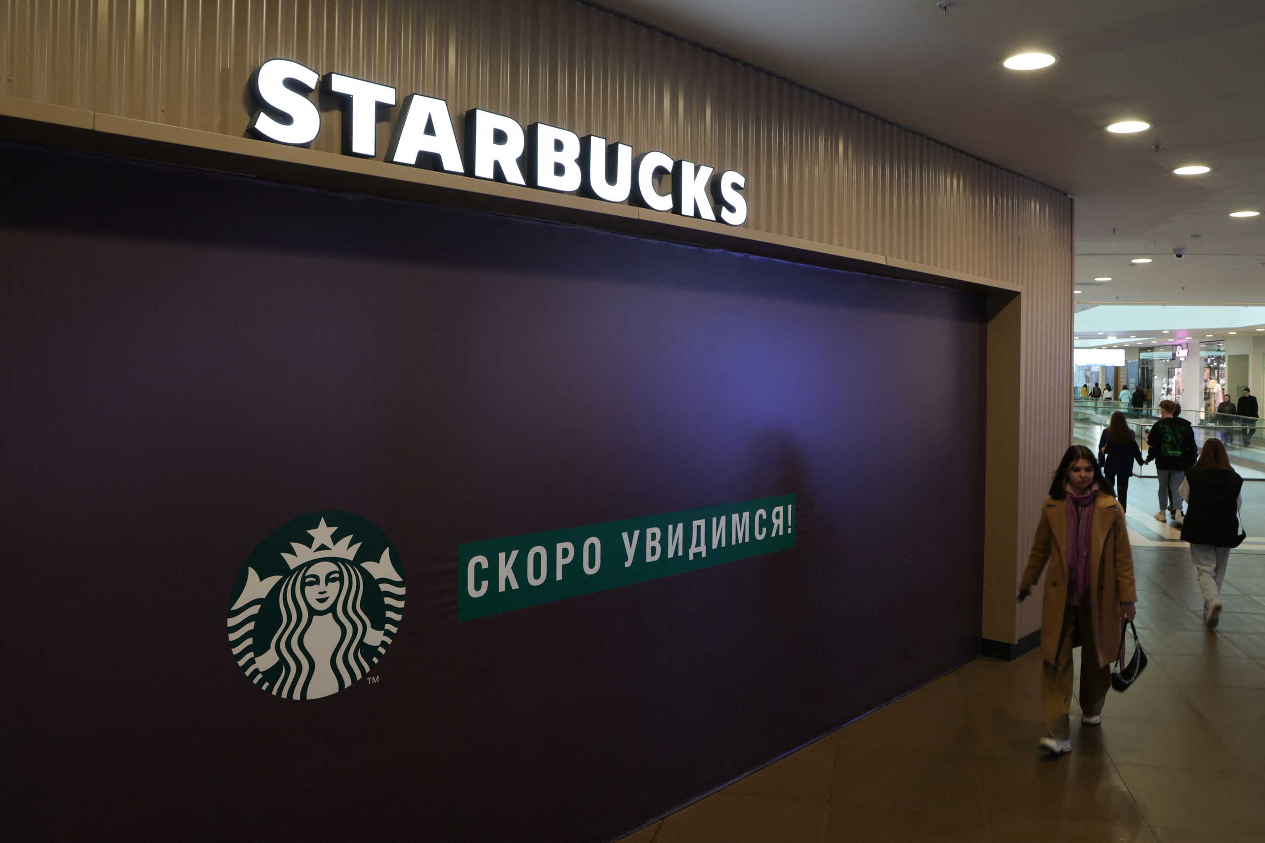 A woman walks past a closed Starbucks cafe in central Saint Petersburg, Russia May 23, 2022.  REUTERS