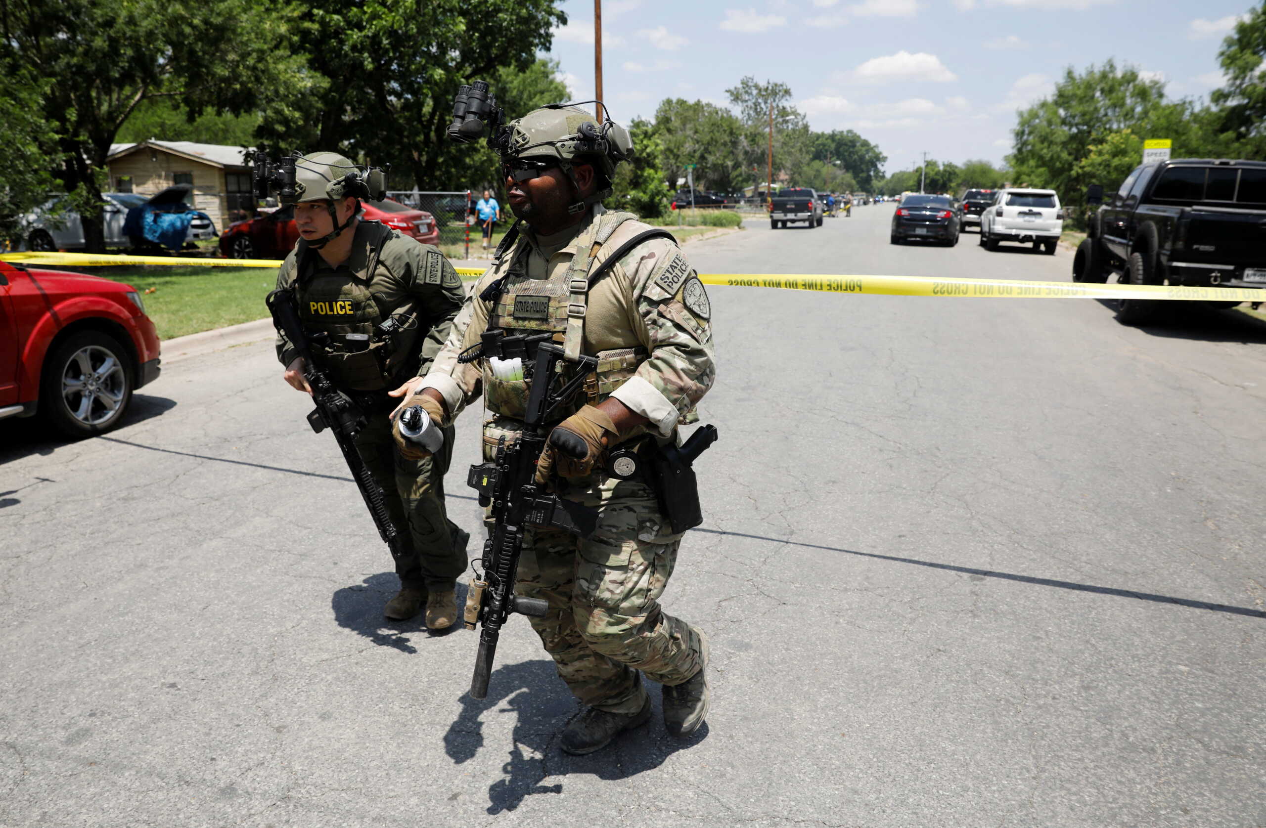 Law enforcement personnel run away from the scene of a suspected shooting near Robb Elementary School in Uvalde, Texas, U.S. May 24, 2022.  REUTERS