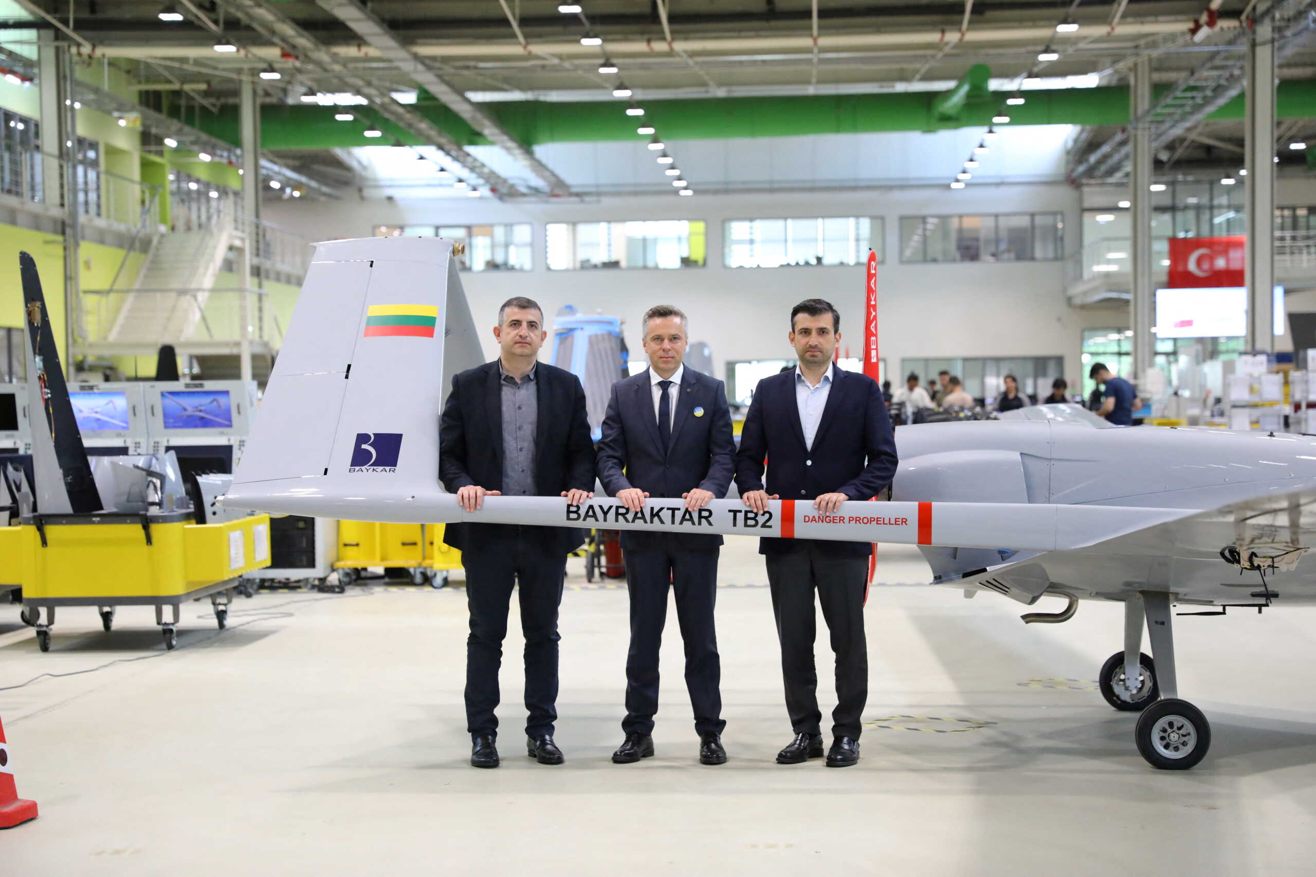 Lithuanian Deputy Defence Minister Vilius Semeska?poses with Selcuk Bayraktar, Chief Technology Officer of Turkish technology company Baykar, and Haluk Bayraktar, Chief Executive Officer of Baykar, next a Bayraktar TB2 advanced combat drone in Istanbul, Turkey June 2, 2022. Baykar