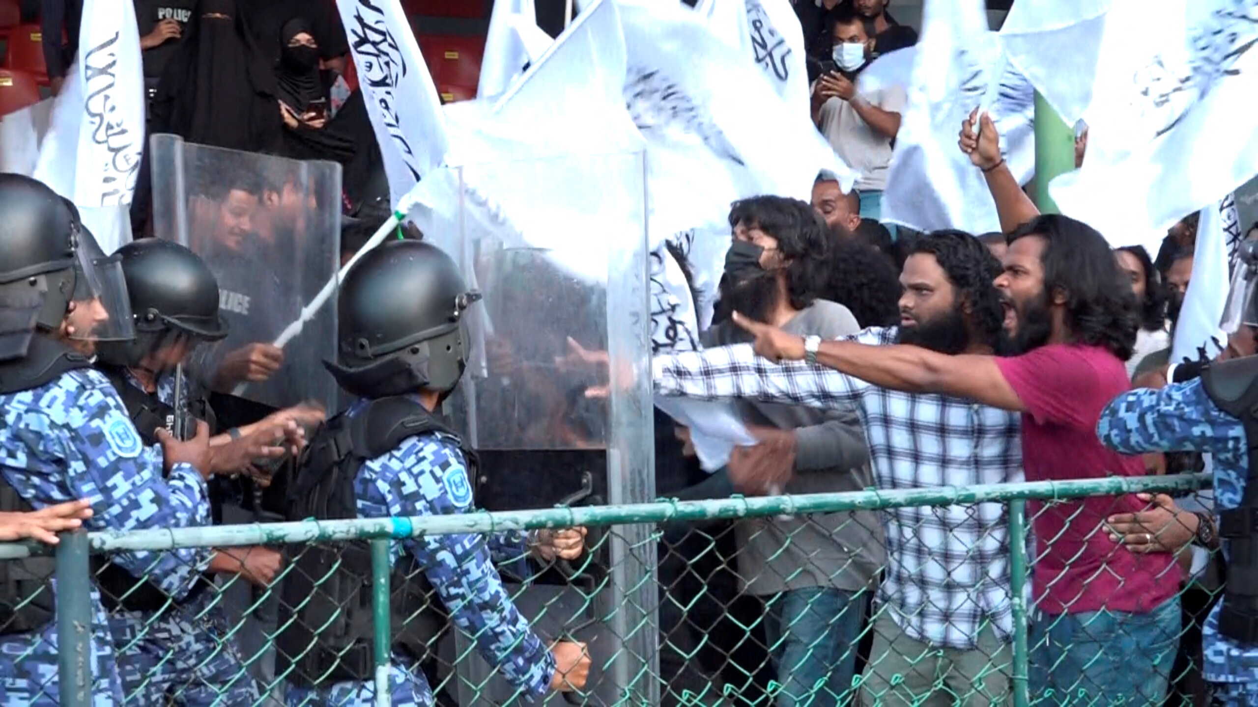 Protesters clash with the police as they disrupt an event celebrating International Day of Yoga, organised by the Indian High Commission at a stadium in Male, Maldives, June 21, 2022, in this still image obtained from a video. Raajje TV