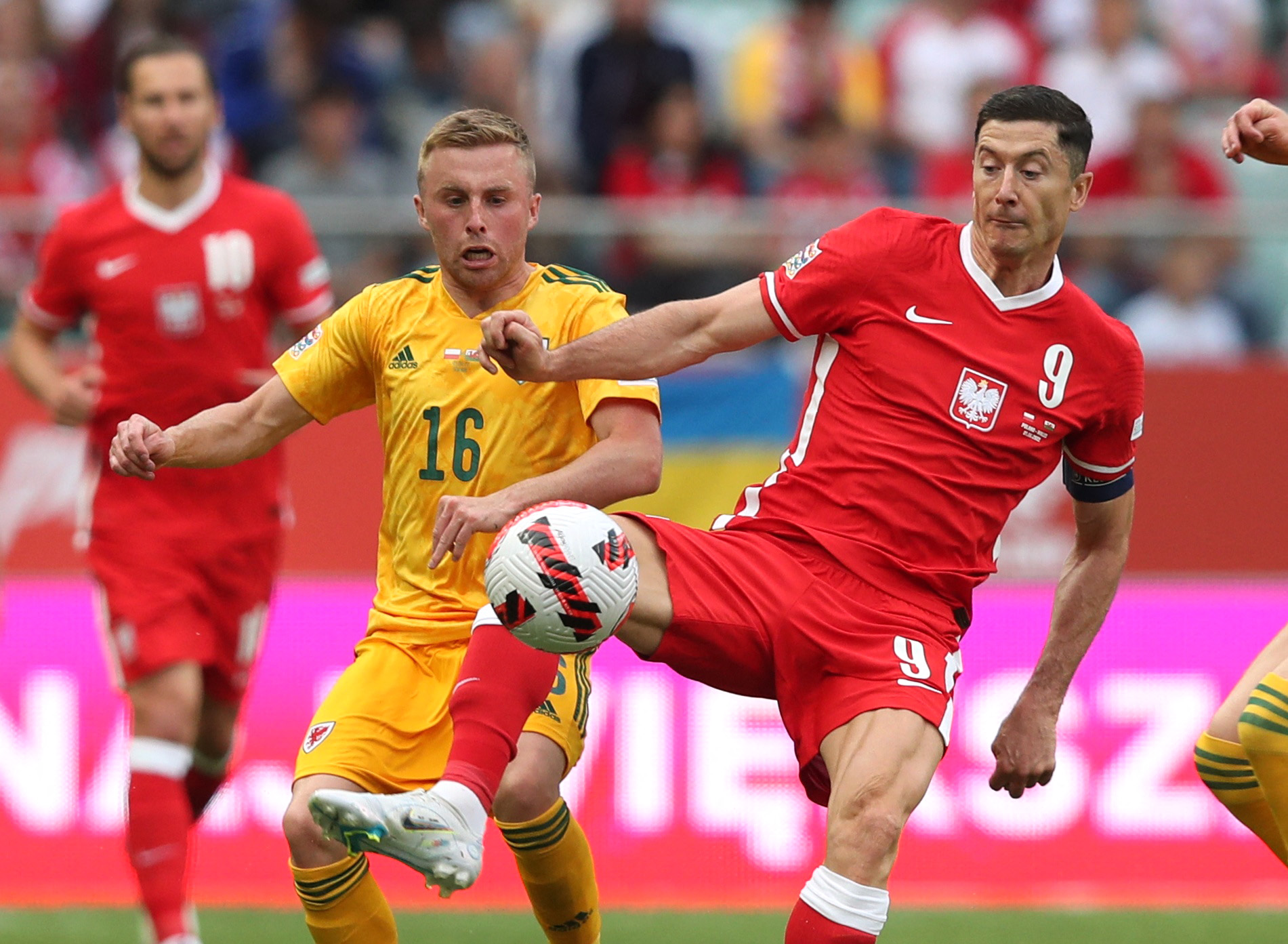 Soccer Football - Nations League - Group D - Poland v Wales - Wroclaw Stadium, Wroclaw, Poland - June 1, 2022 Poland's Robert Lewandowski in action with Wales' Joe Morrell REUTERS
