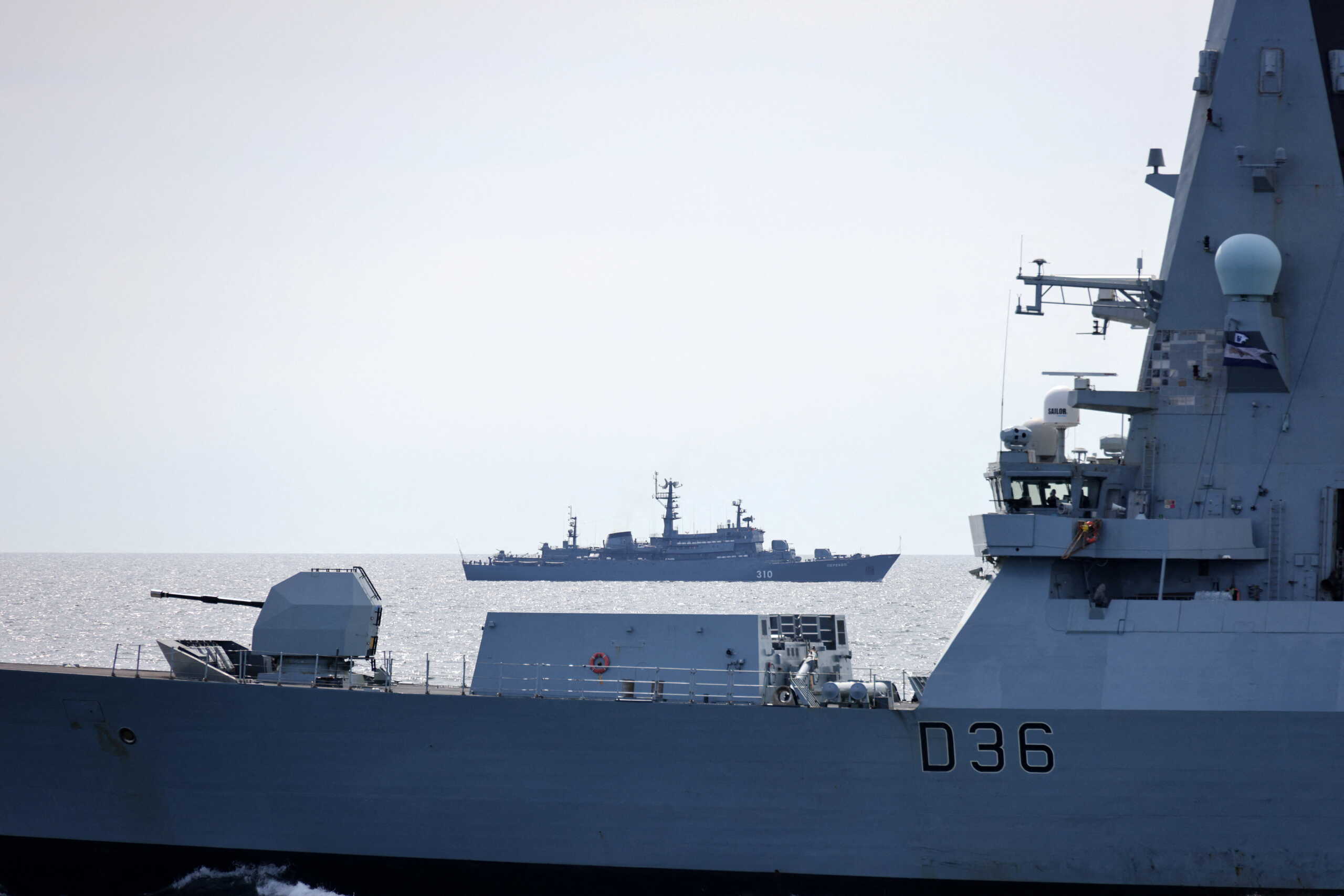 A Russian navy ship sails in the distance as Britain's Royal Navy HMS Defender (D114) takes part in the Baltops 22 exercise in Baltic Sea, June 6, 2022. Picture taken June 6, 2022. REUTERS