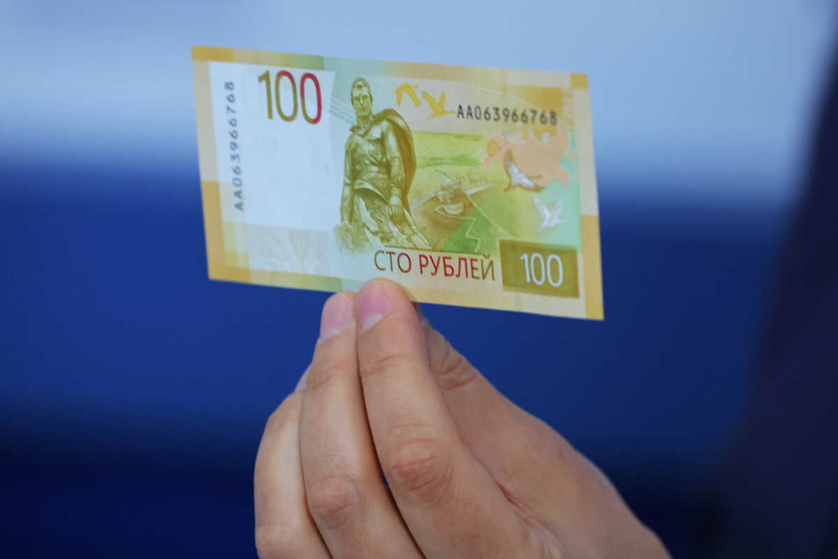 Deputy Governor of the Bank of Russia Sergey Belov holds the newly designed Russian 100-rouble banknote during a presentation in Moscow, Russia June 30, 2022. REUTERS