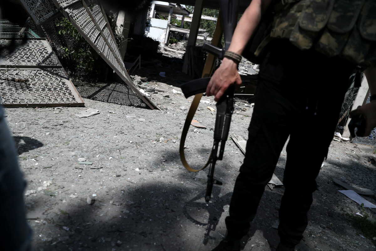A policeman stands guard in front of a damaged school after a missile strike, amid Russia's attack on Ukraine, at a residential area in Kharkiv, Ukraine Jun 2, 2022. REUTERS