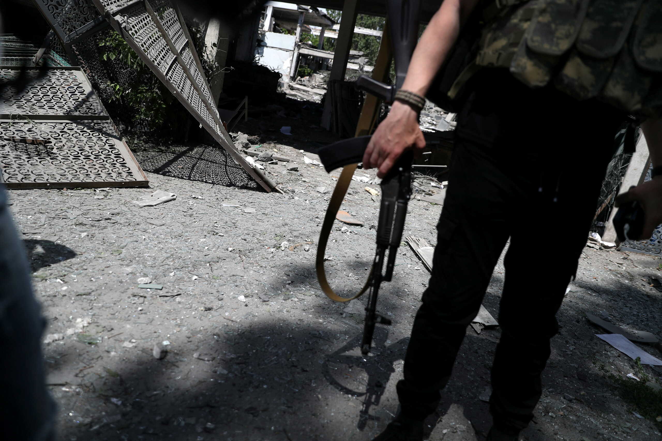 A policeman stands guard in front of a damaged school after a missile strike, amid Russia's attack on Ukraine, at a residential area in Kharkiv, Ukraine Jun 2, 2022. REUTERS