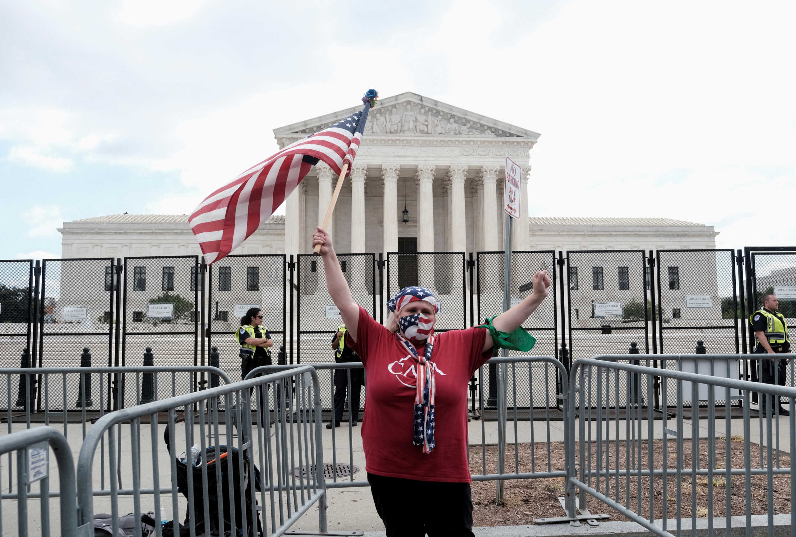 A demonstrator holds the U.S national flag outside the United States Supreme Court as the court rules in the Dobbs v Women's Health Organization abortion case, overturning the landmark Roe v Wade abortion decision in Washington, U.S., June 24, 2022. REUTERS