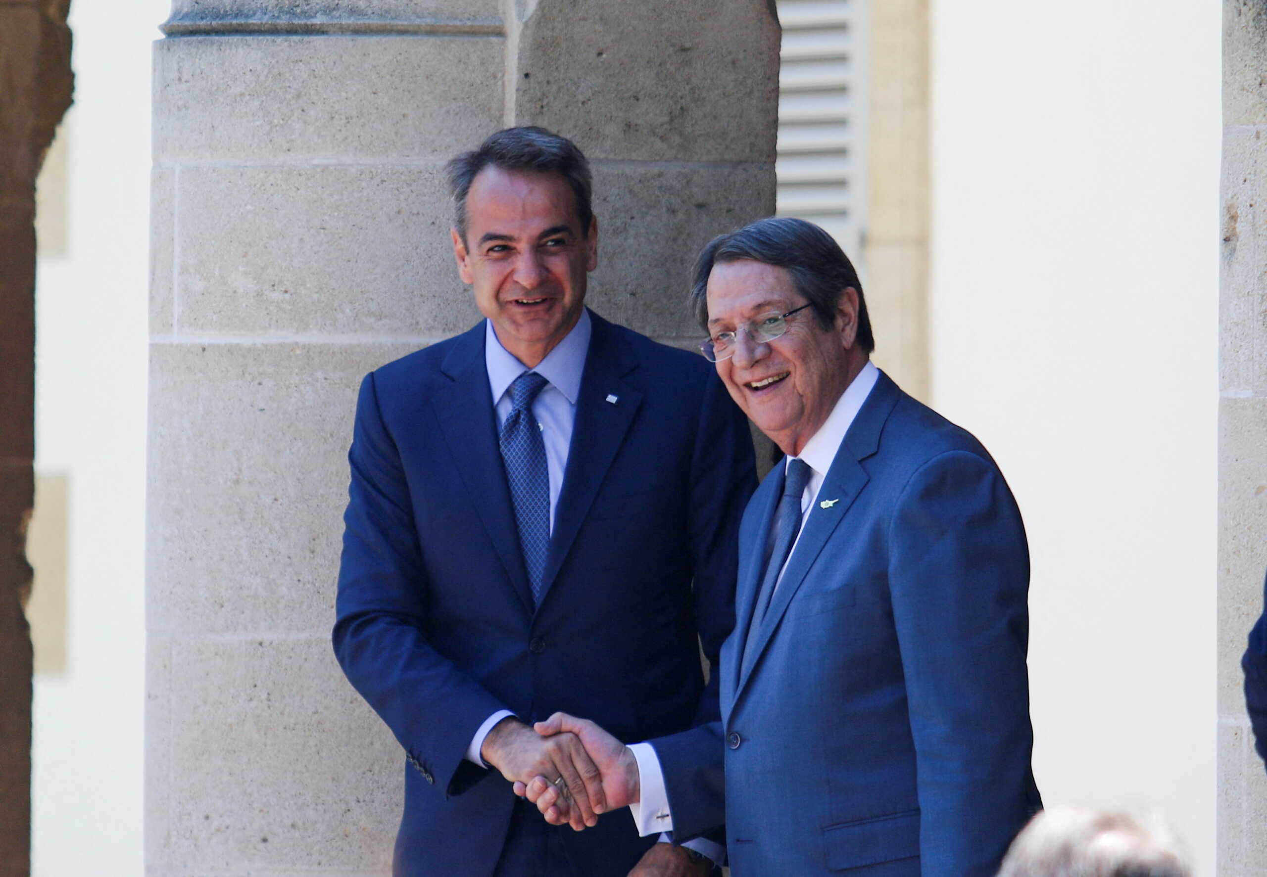 Cypriot President Nicos Anastasiades shakes hands with Greek Prime Minister Kyriakos Mitsotakis before a meeting at the Presidential Palace in Nicosia, Cyprus June 17, 2022. REUTERS