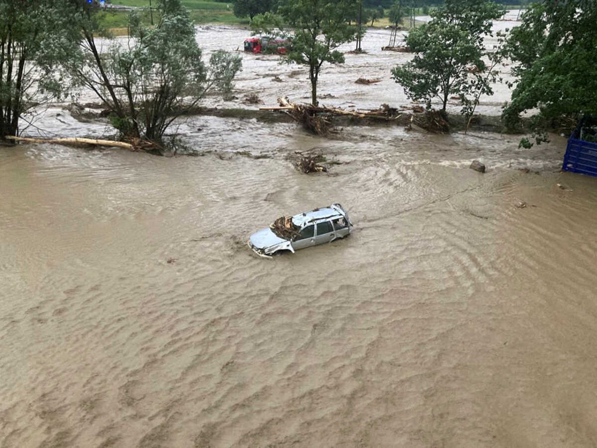 A flooded car is seen after heavy rains and a mudslide in Austria's southern region of Carinthia near Villach, Austria June 29, 2022. Federal Police