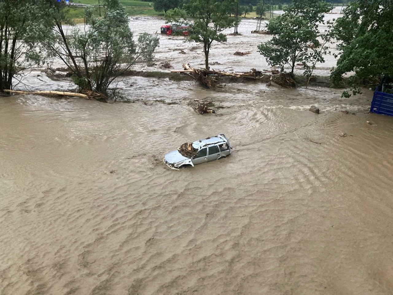 A flooded car is seen after heavy rains and a mudslide in Austria's southern region of Carinthia near Villach, Austria June 29, 2022. Federal Police