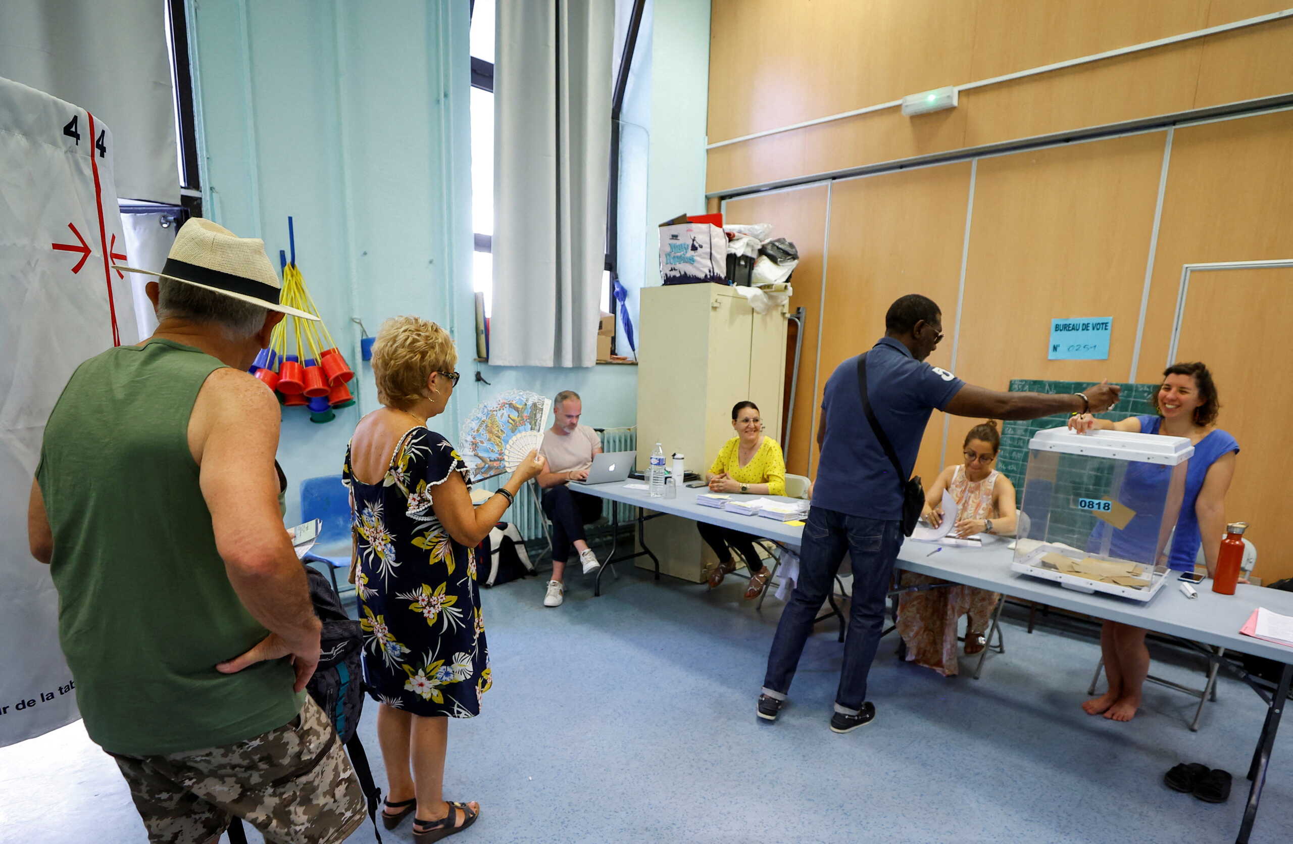 Voters stand in line to cast their ballots in the second round of the French parliamentary elections, at a polling station in Marseille, France, June 19 2022. REUTERS