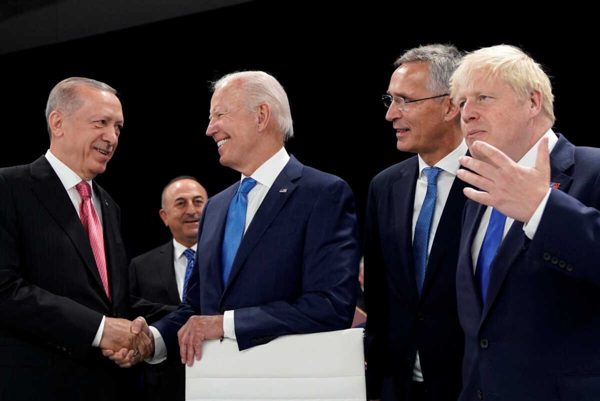 Turkish President Recep Tayyip Erdogan and U.S. President Joe Biden shakes hands as NATO Secretary General Jens Stoltenberg and British Prime Minister Boris Johnson look on during a round table meeting at a NATO summit in Madrid, Spain June 29, 2022. Susan Walsh