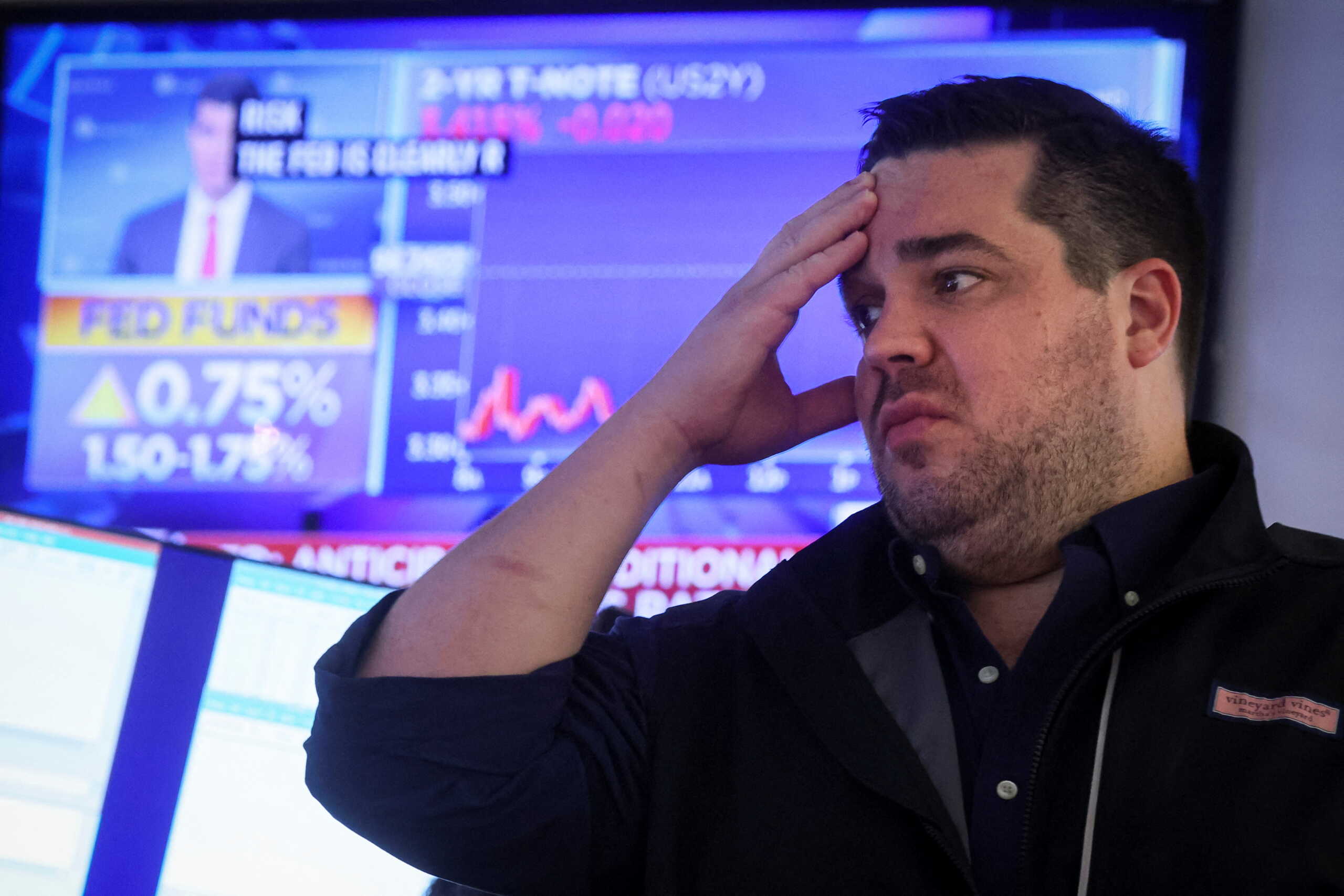 A screen displays the Fed rate announcement as a trader works (inside a post) on the floor of the New York Stock Exchange (NYSE) in New York City, U.S., June 15, 2022.  REUTERS