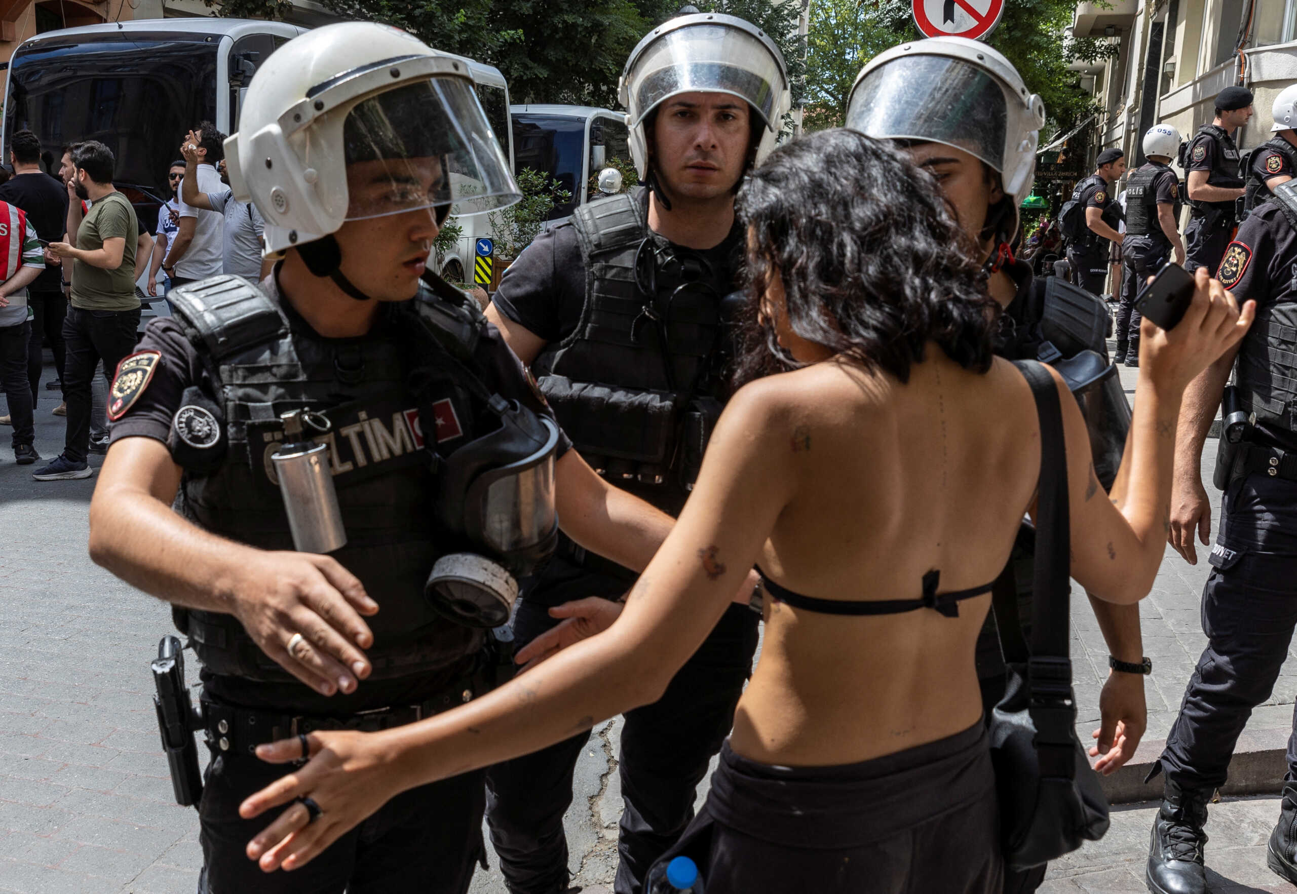 Police officers prevent an activist from marching in a pride parade, which was banned by local authorities, in central Istanbul, Turkey June 26, 2022. REUTERS