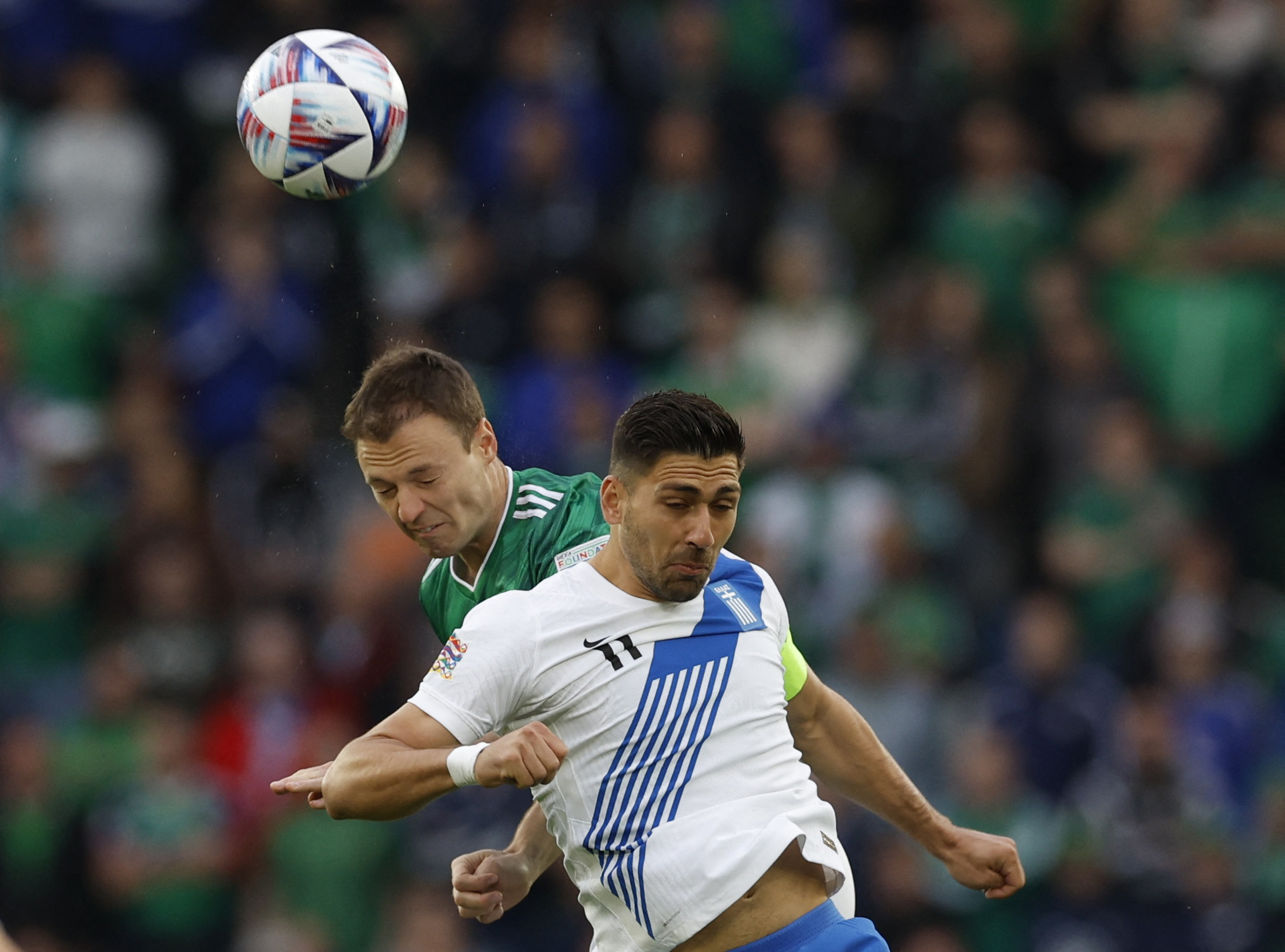 Soccer Football - UEFA Nations League - Group J - Northern Ireland v Greece - Windsor Park, Belfast, Northern Ireland, Britain - June 2, 2022 Northern Ireland's Jonny Evans in action with Greece's Anastasios Bakasetas Action Images via Reuters