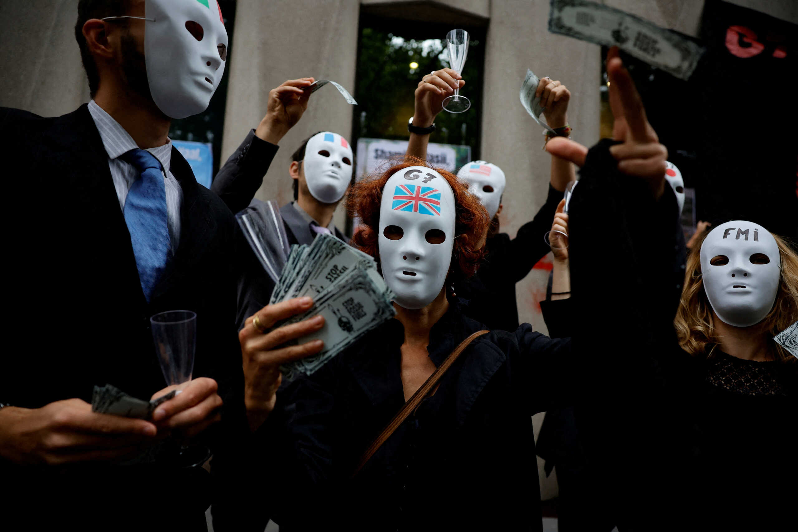 Activists attend an action "Debt for climate" to demand from the G7 the cancellation of the debt for countries of the Global South, in front of the International Monetary Fund (IMF) offices in Paris, France, June 27, 2022. REUTERS