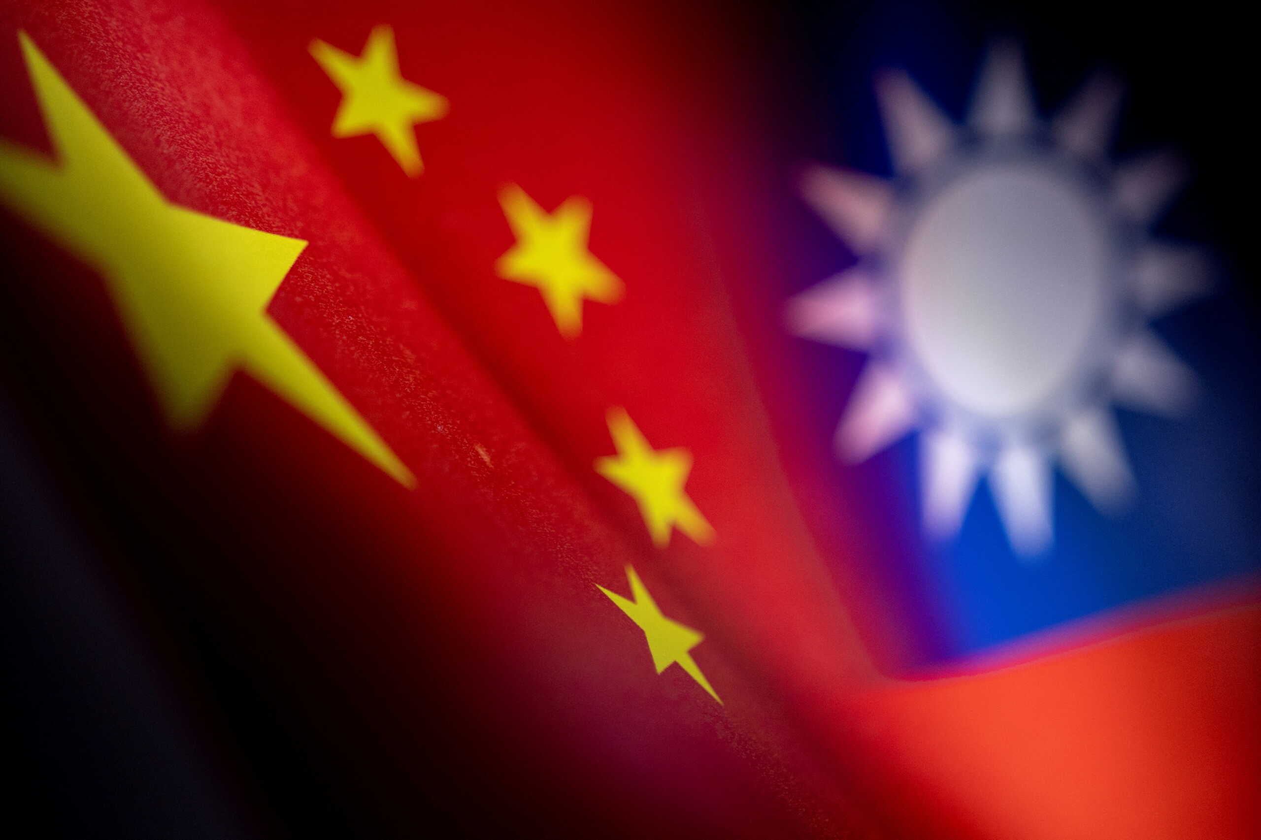 FILE PHOTO: Chinese and Taiwanese printed flags are seen in this illustration taken, April 28, 2022. REUTERS